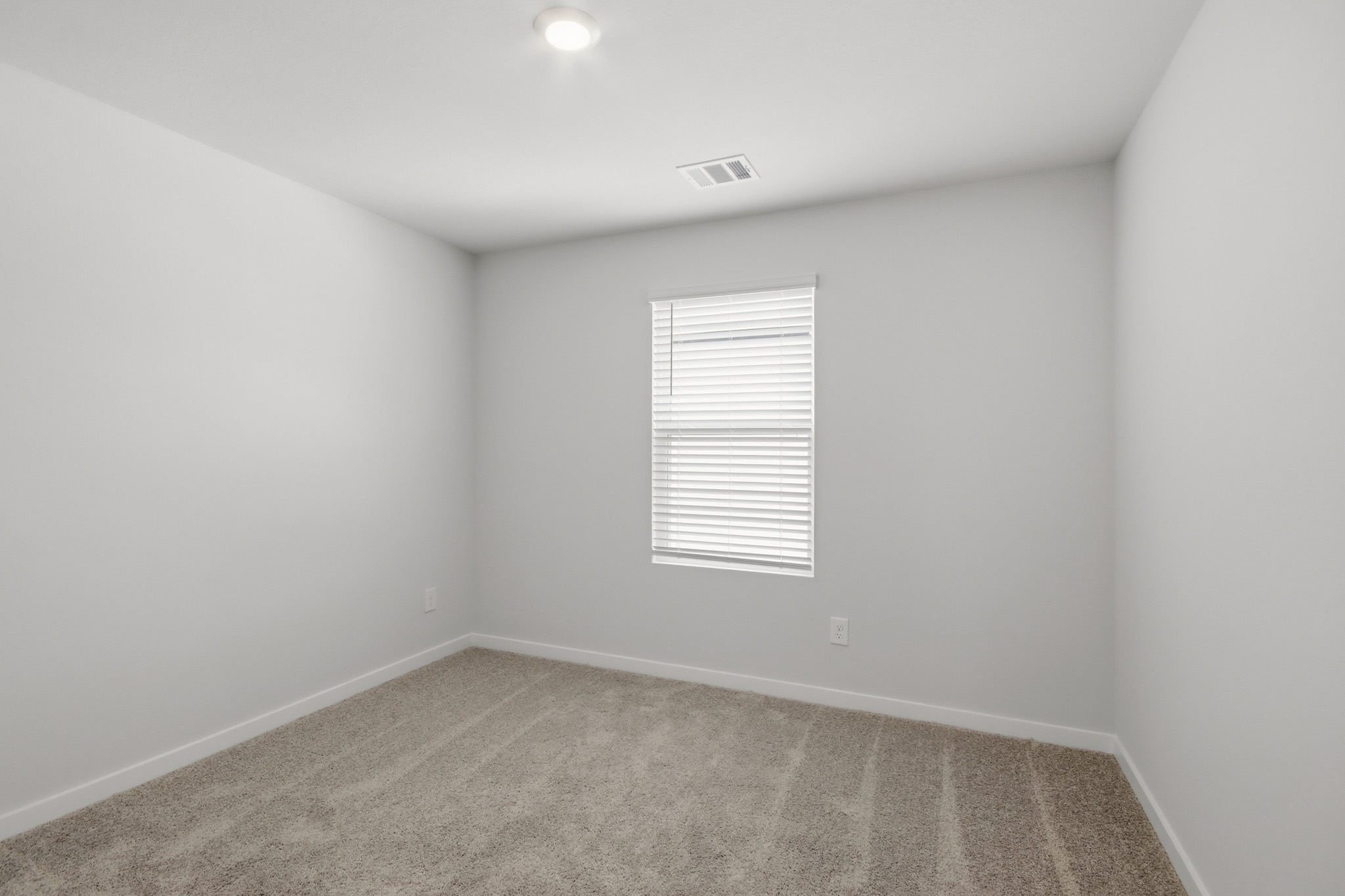 A room with a door and a carpet.