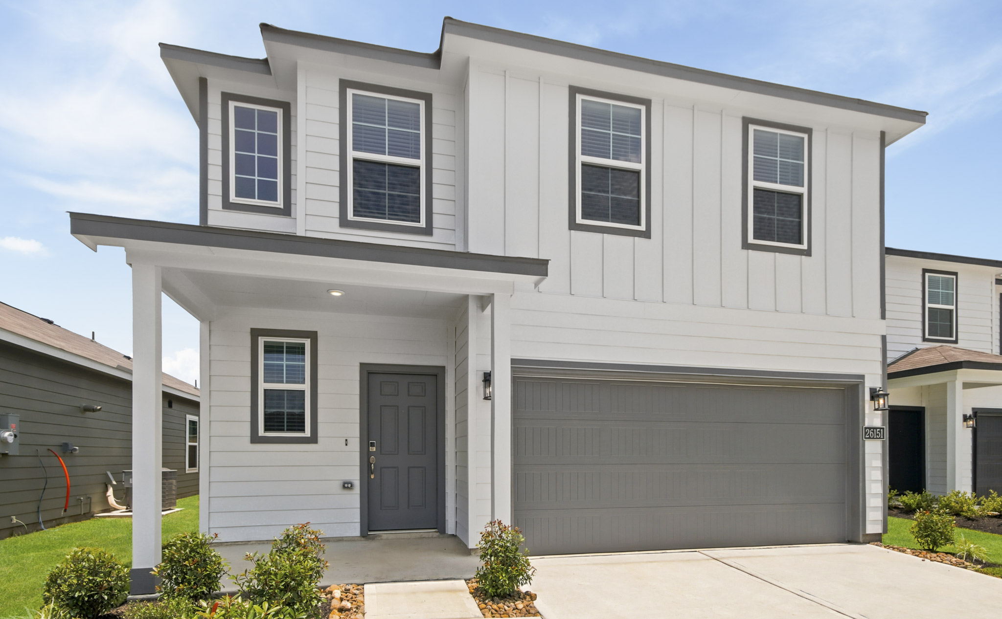 A white house with a garage.