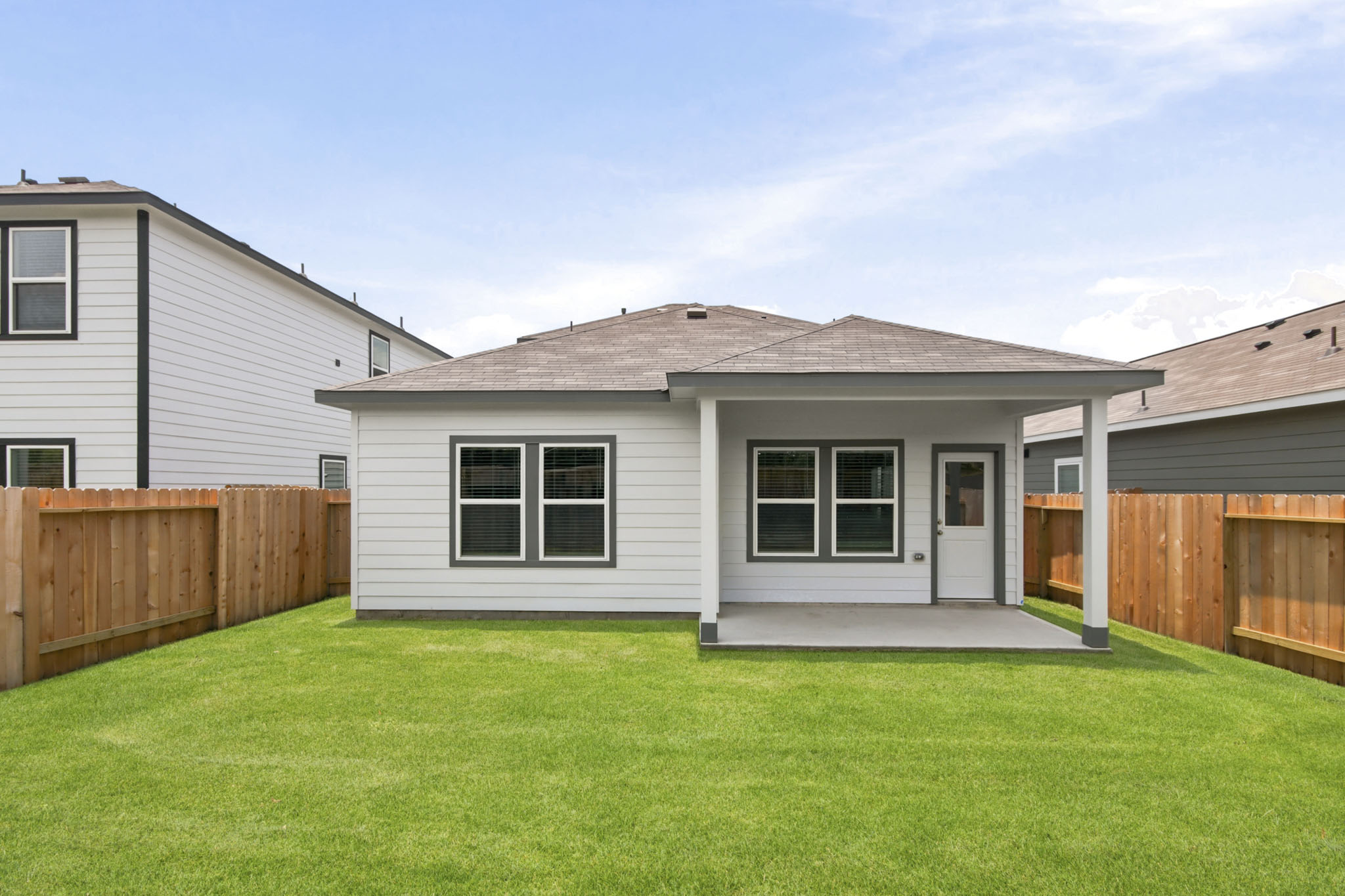 A house with a fence and grass.
