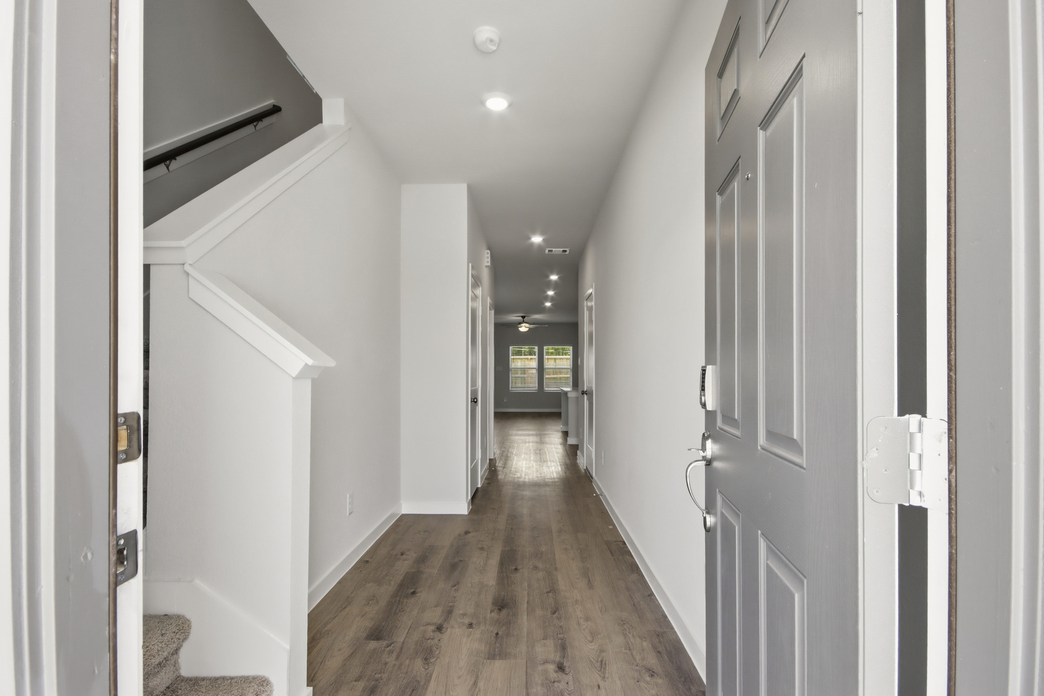 A hallway with white doors.
