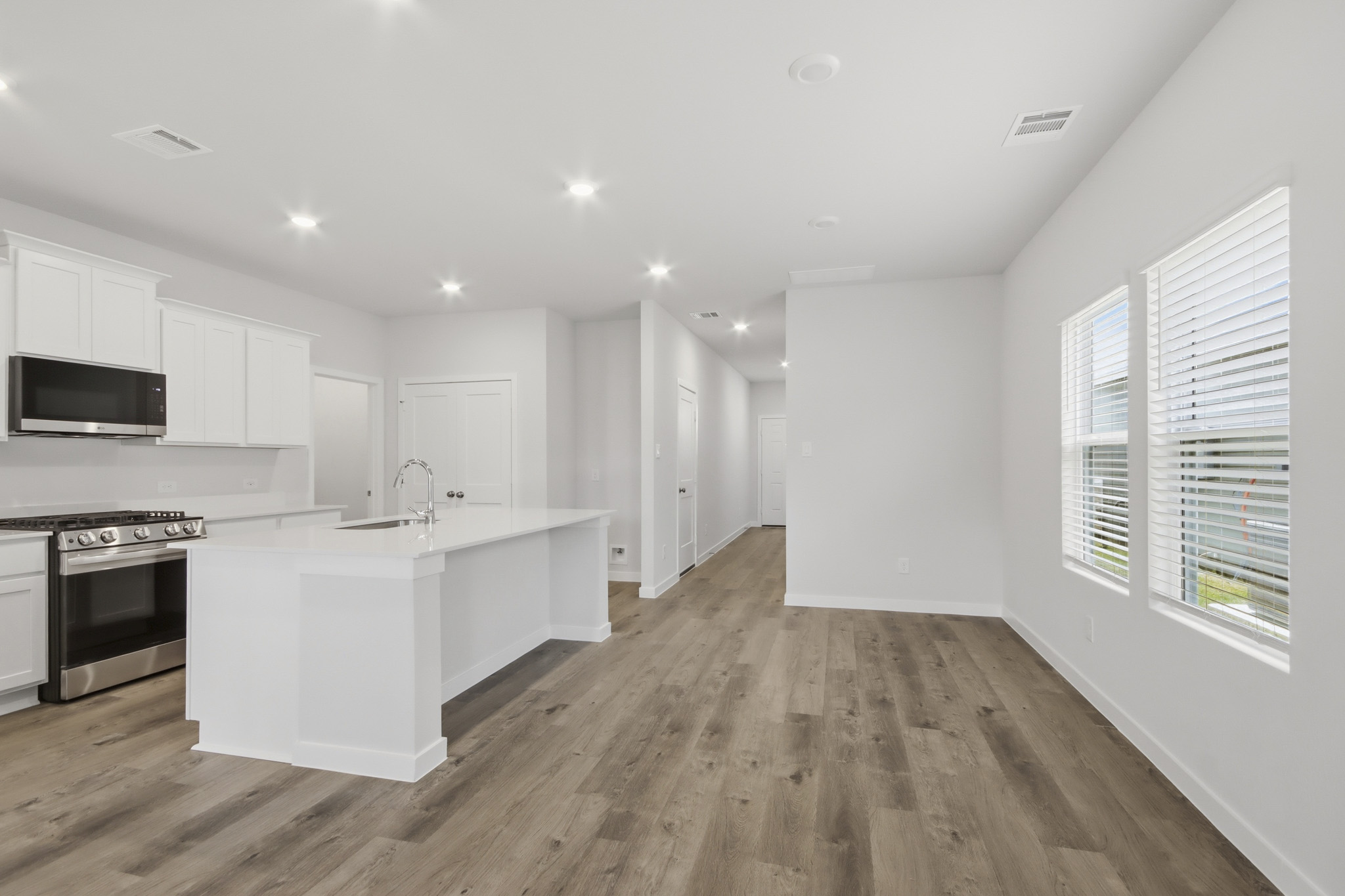 A kitchen with white cabinets.