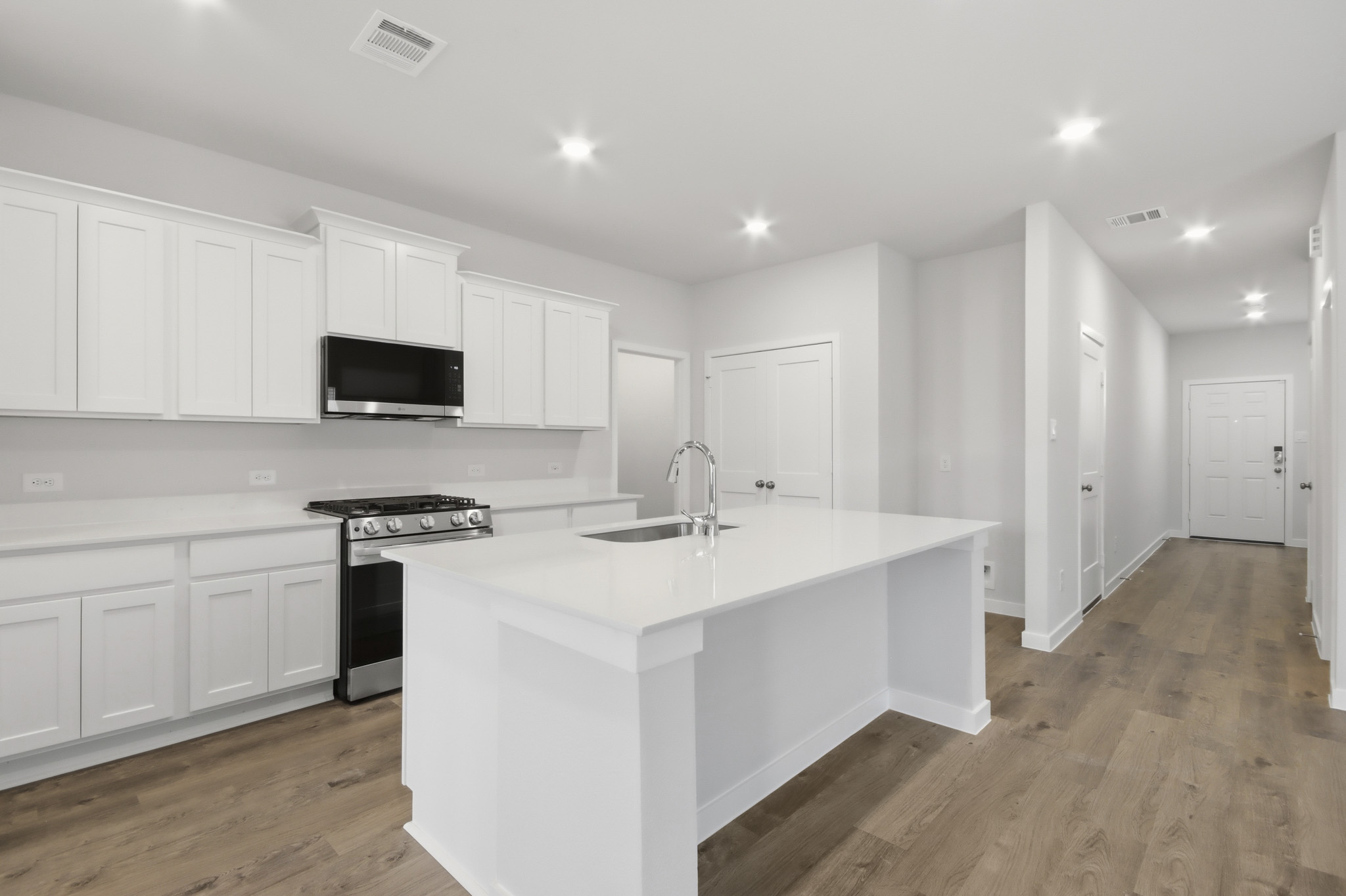 A kitchen with white cabinets.