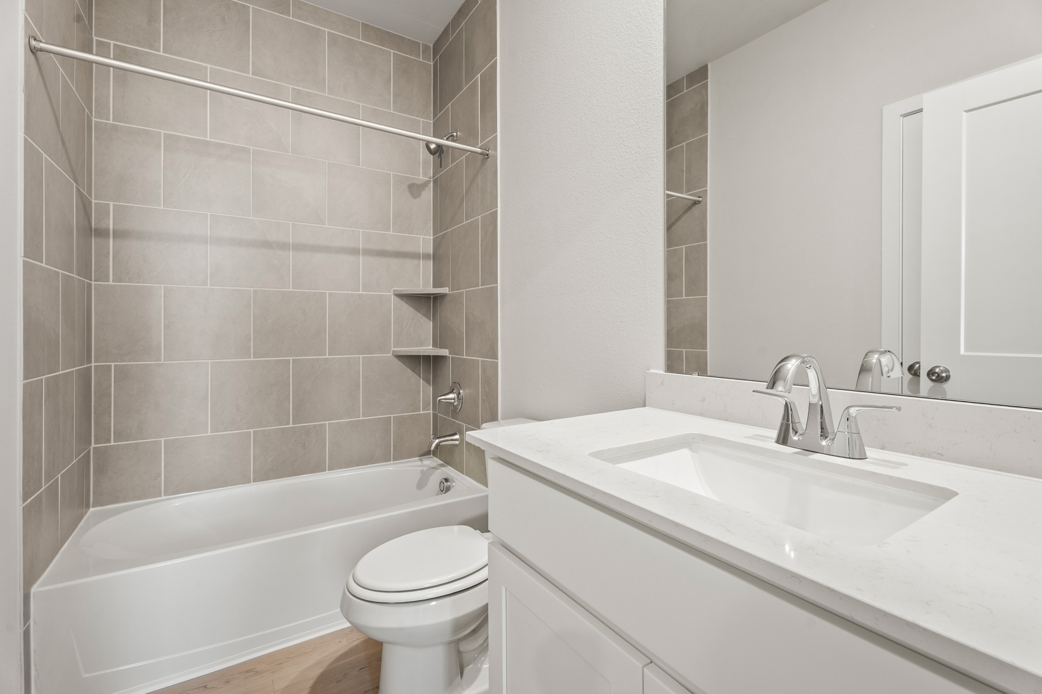 A bathroom with a tub sink and toilet.