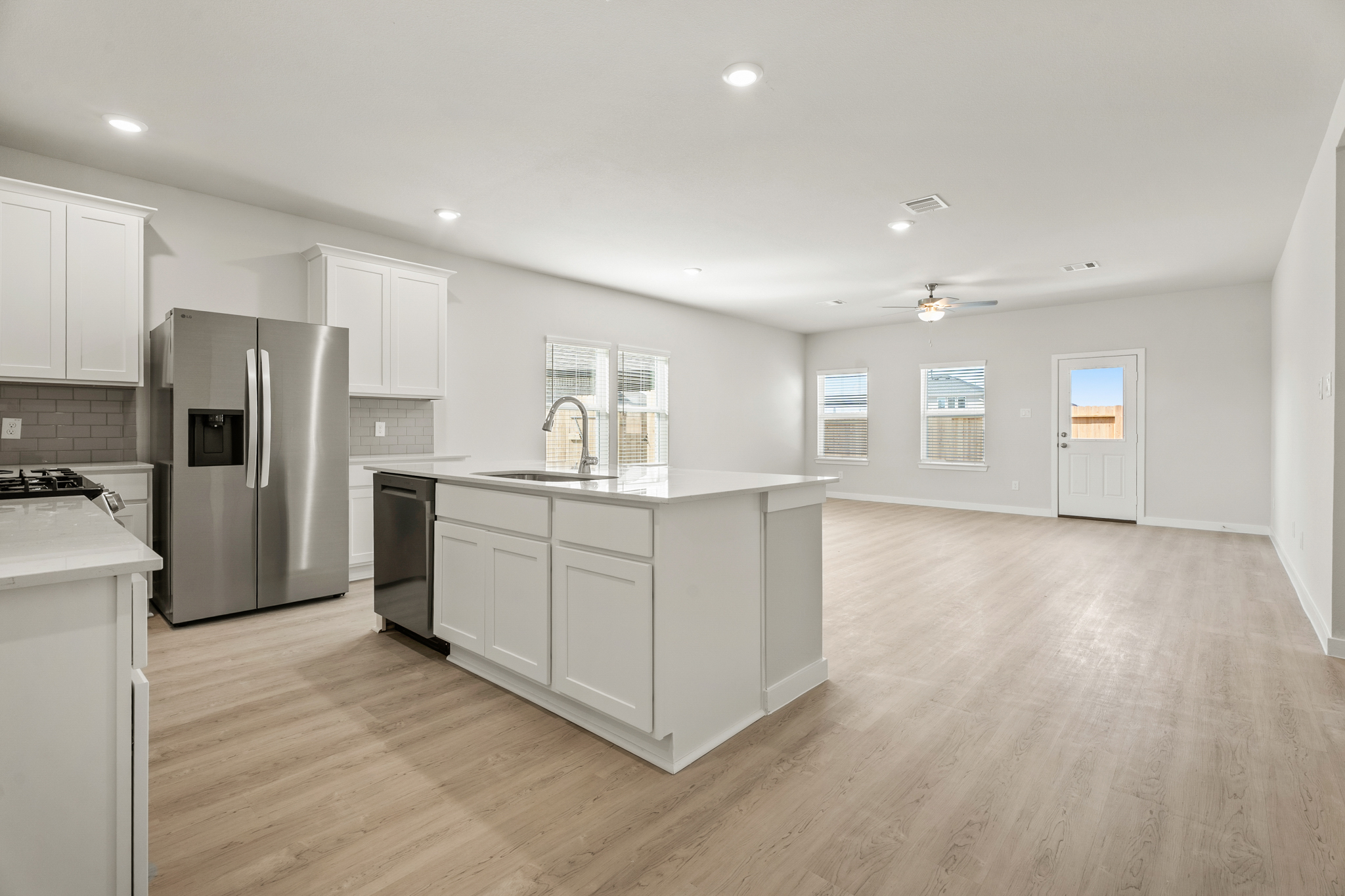 A kitchen with white cabinets.