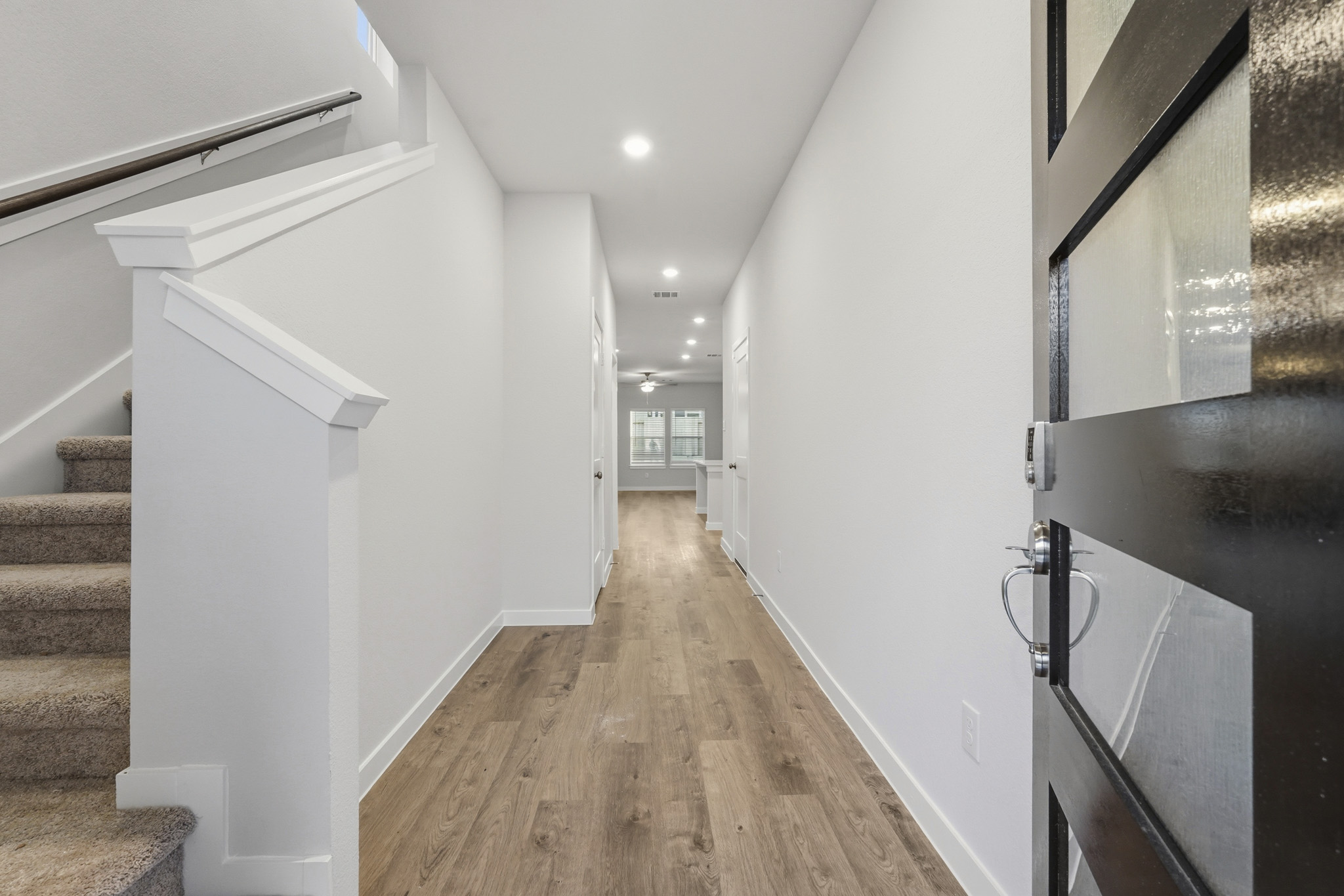 A hallway with white walls.