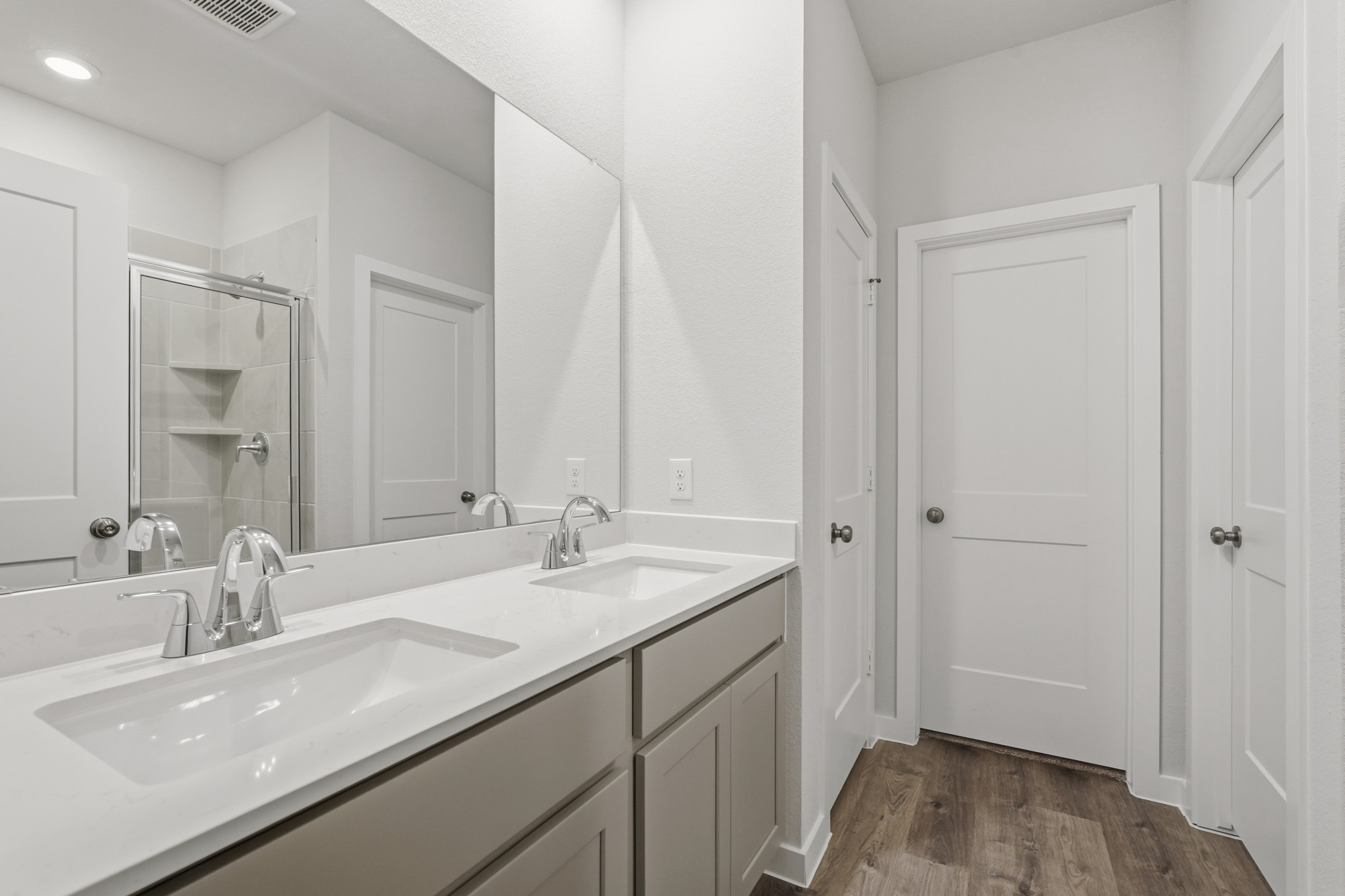 A bathroom with a large mirror.
