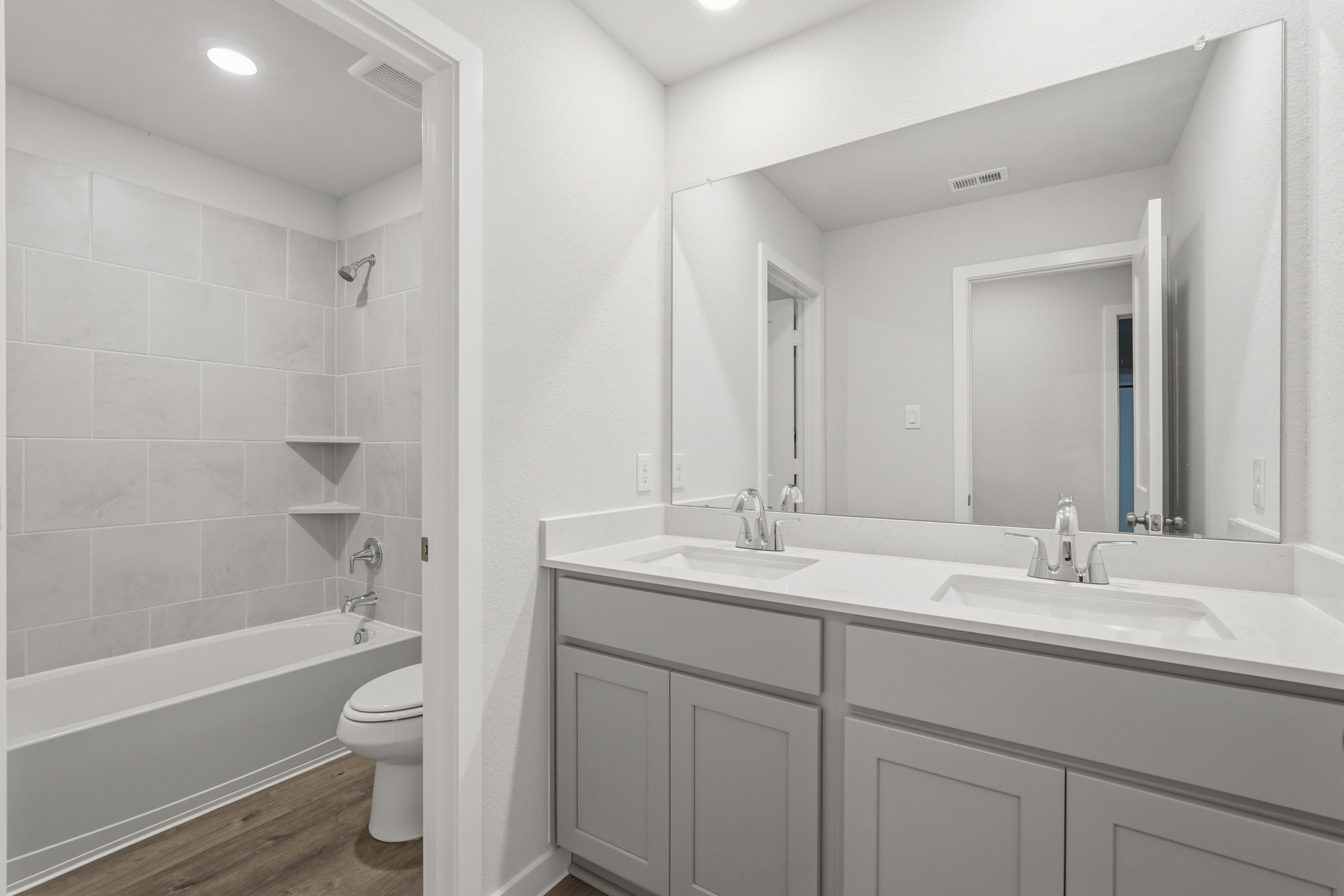 A bathroom with a tub sink and toilet.