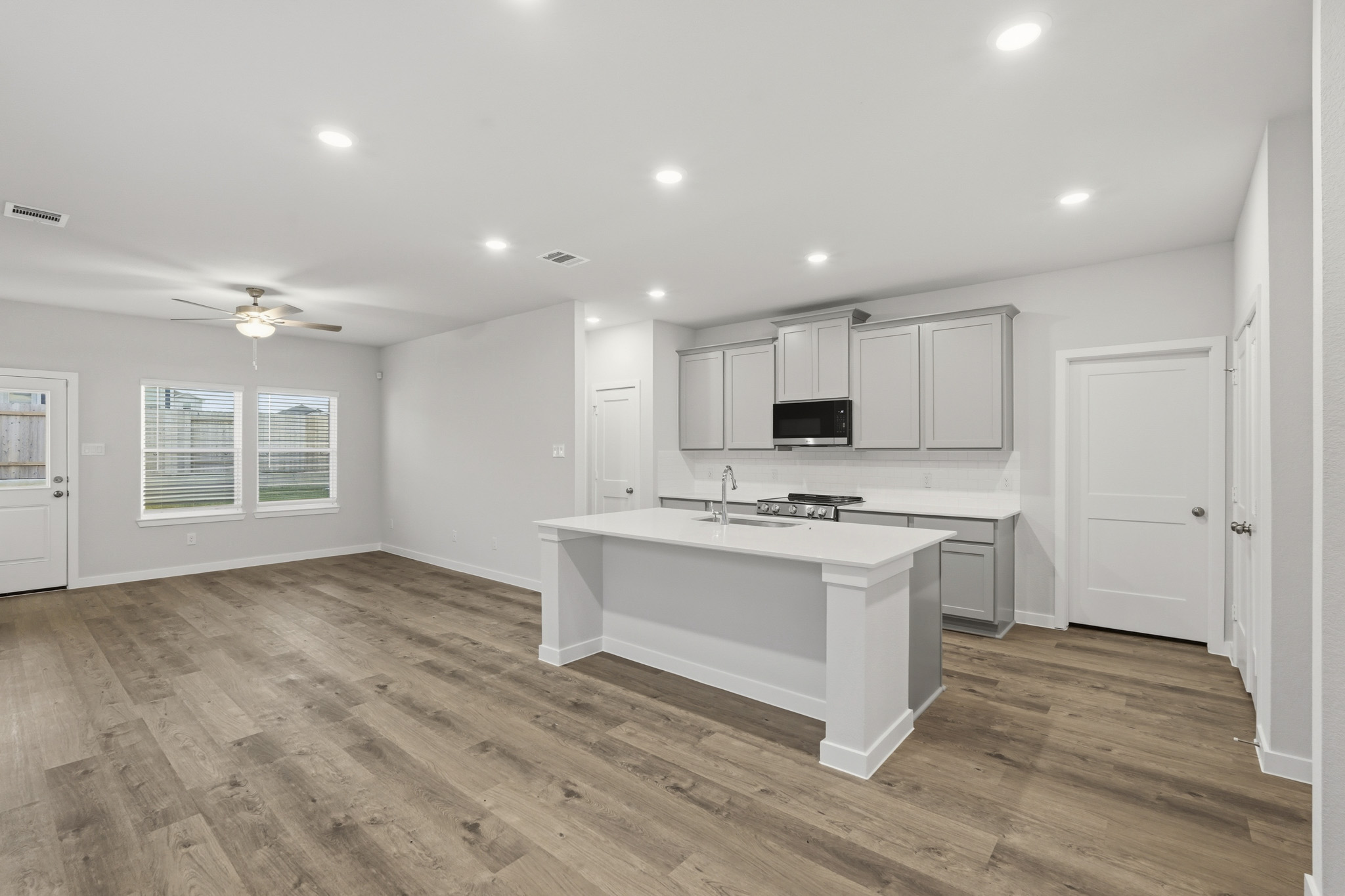 A kitchen with white cabinets.