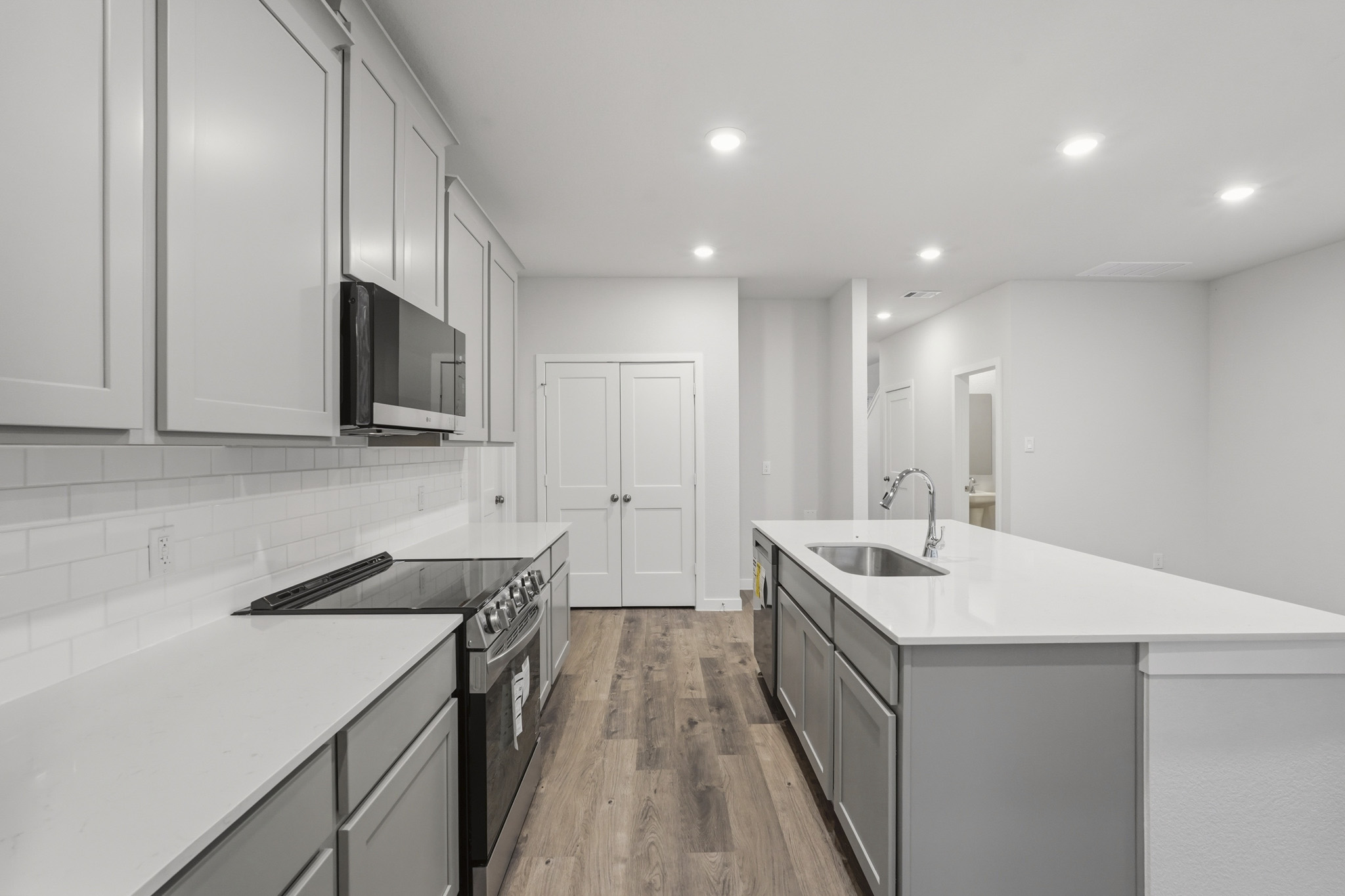 A kitchen with white cabinets.