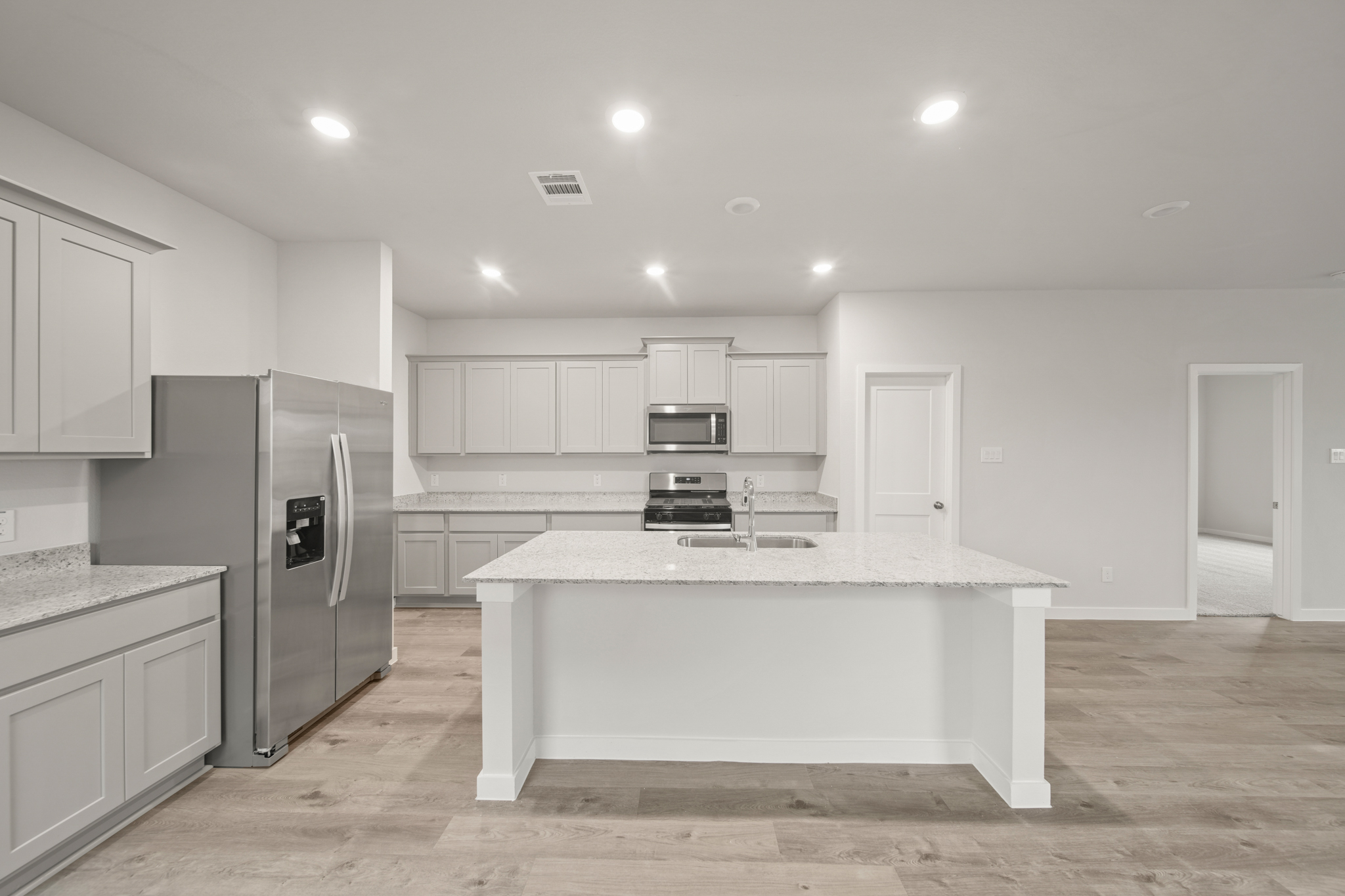 A kitchen with white cabinets.