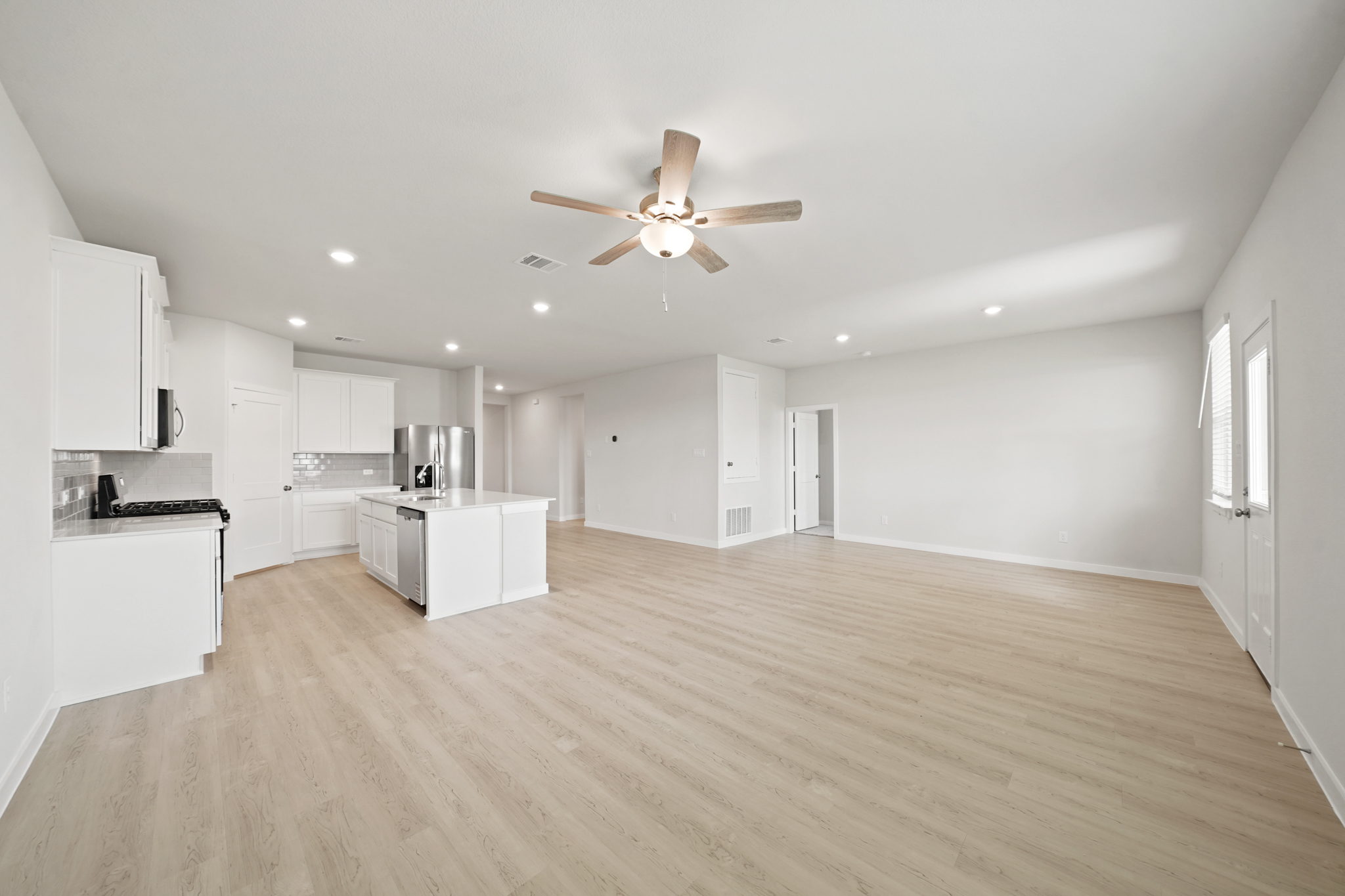 A large kitchen with white cabinets.