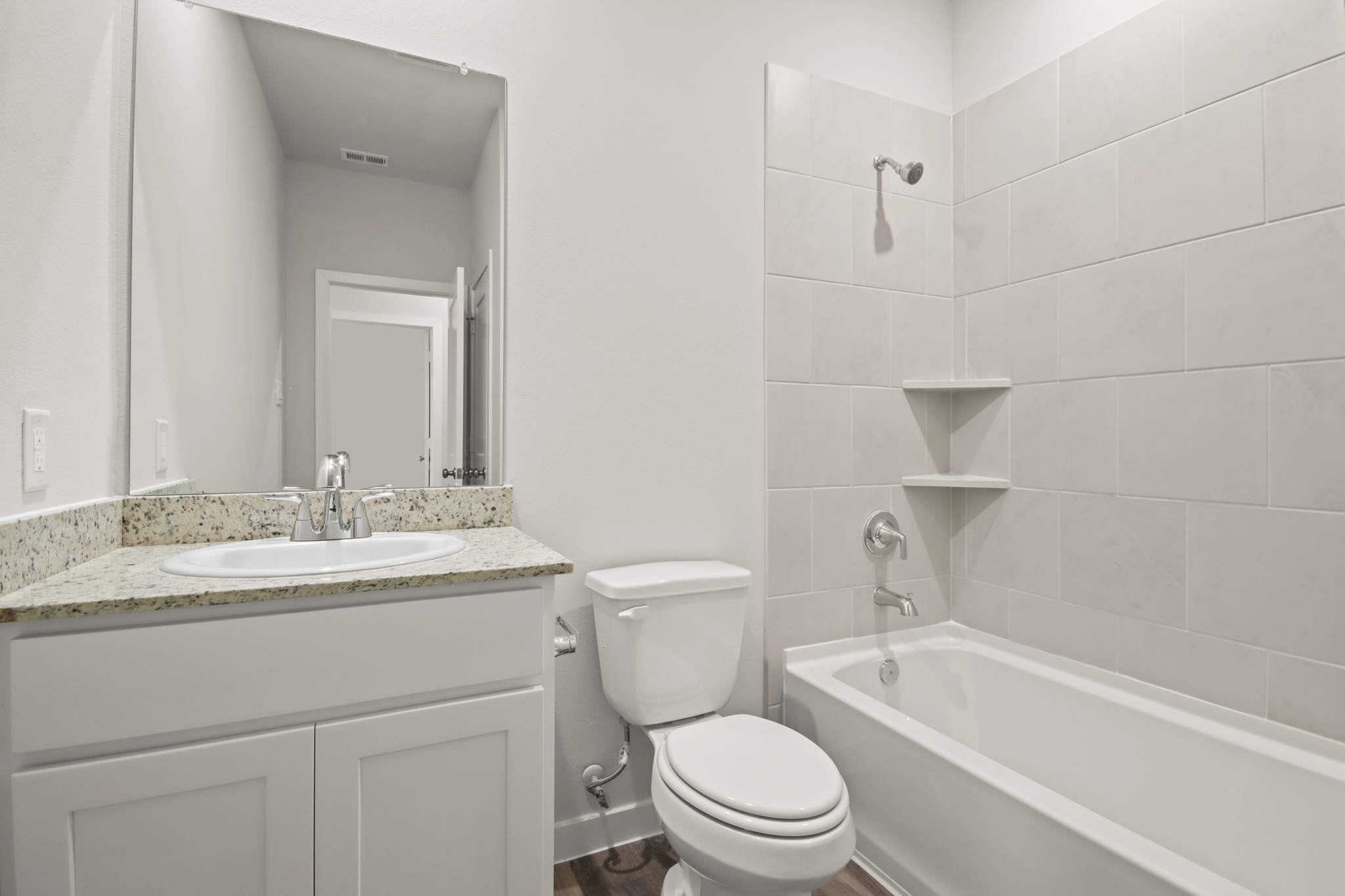A bathroom with a tub sink and toilet.