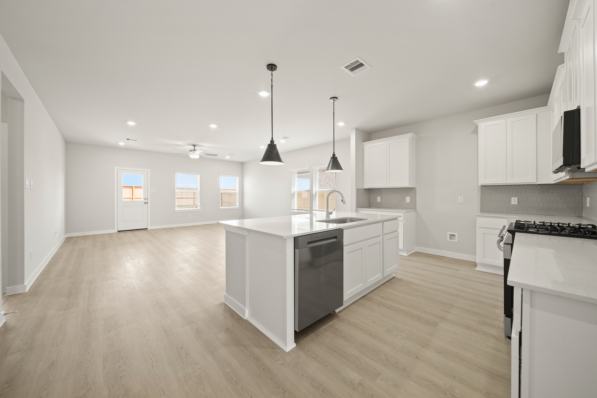 A kitchen with white cabinets.