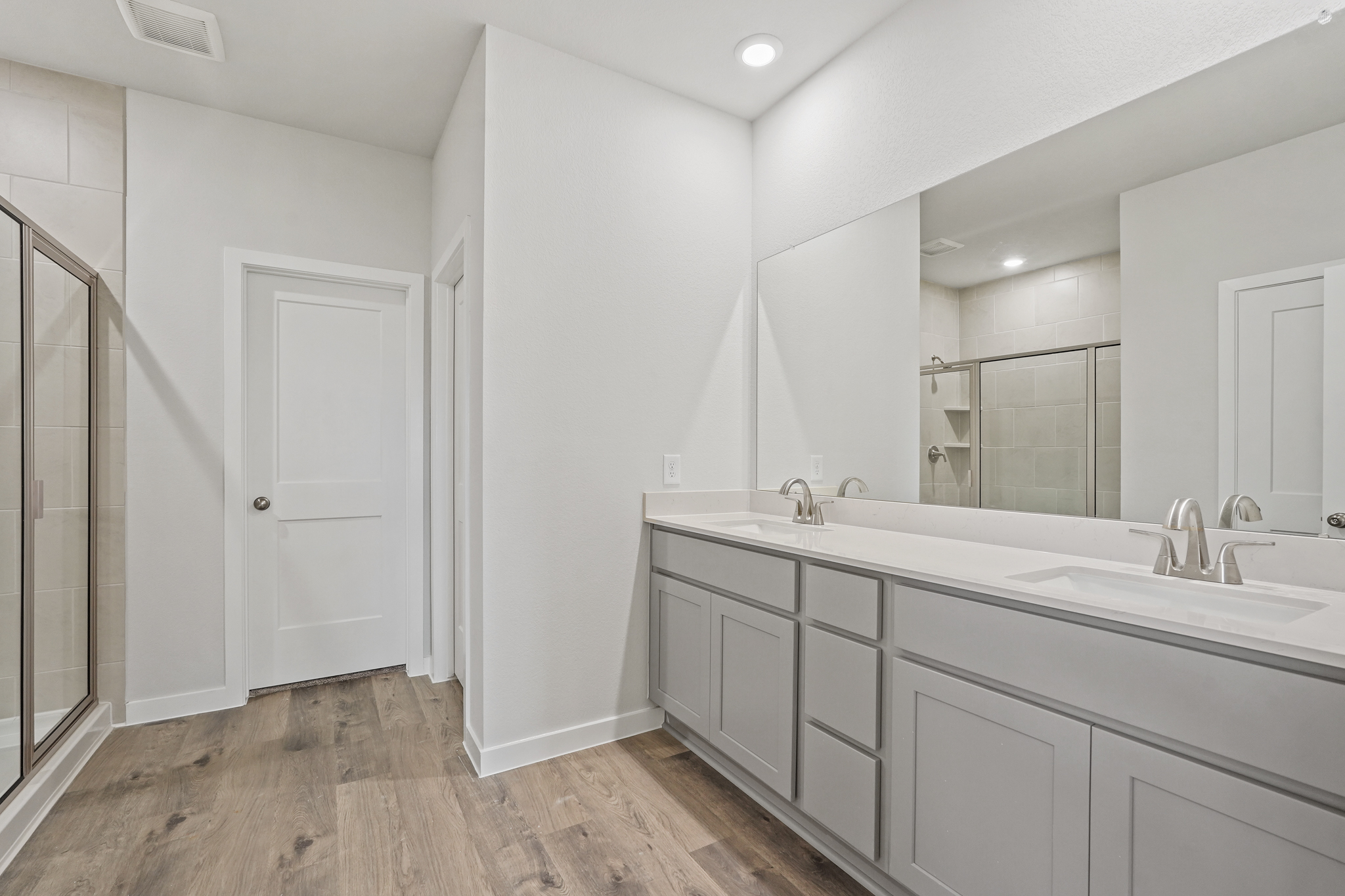 A bathroom with white cabinets.