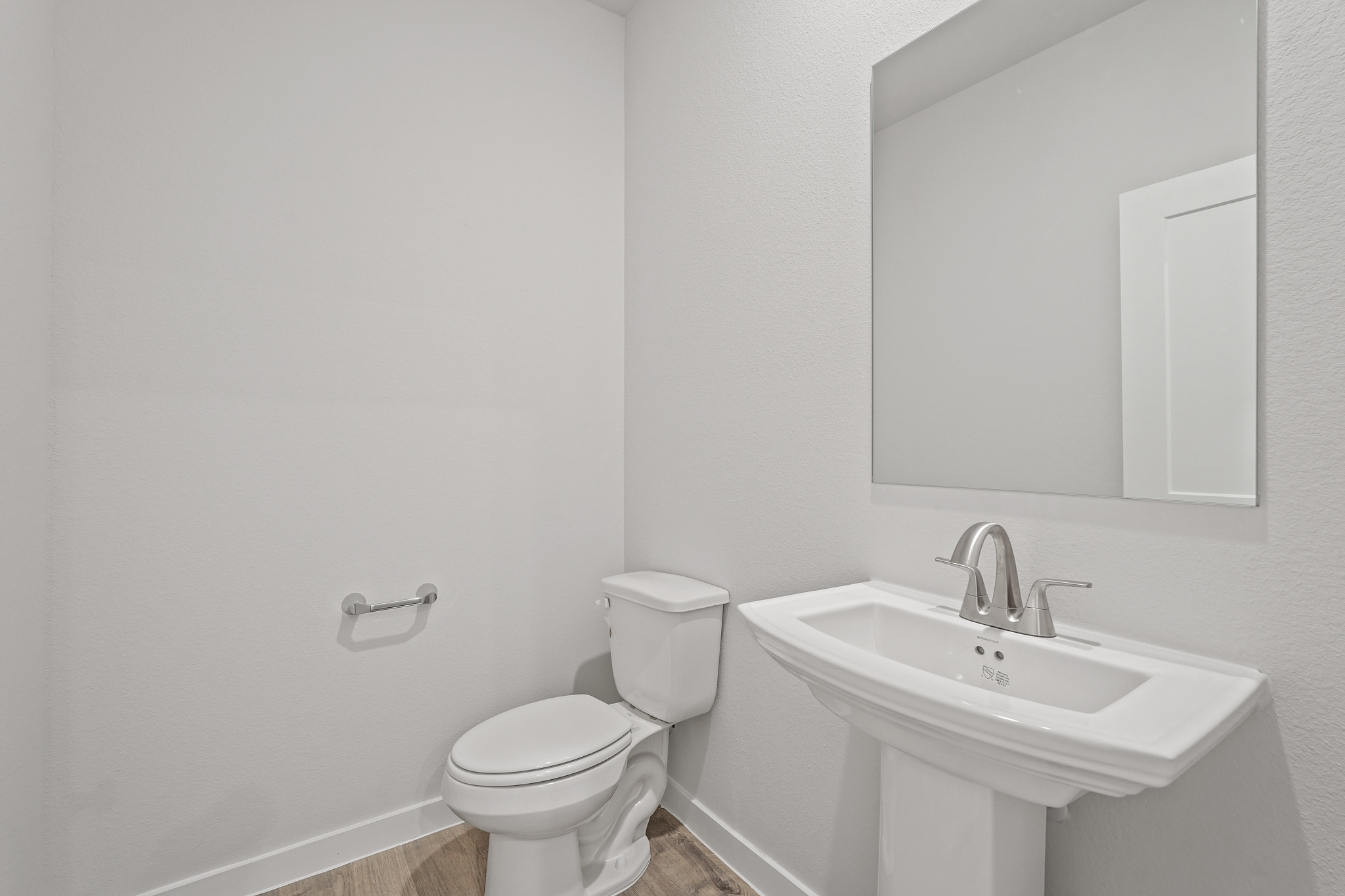 A bathroom with a toilet and sink.