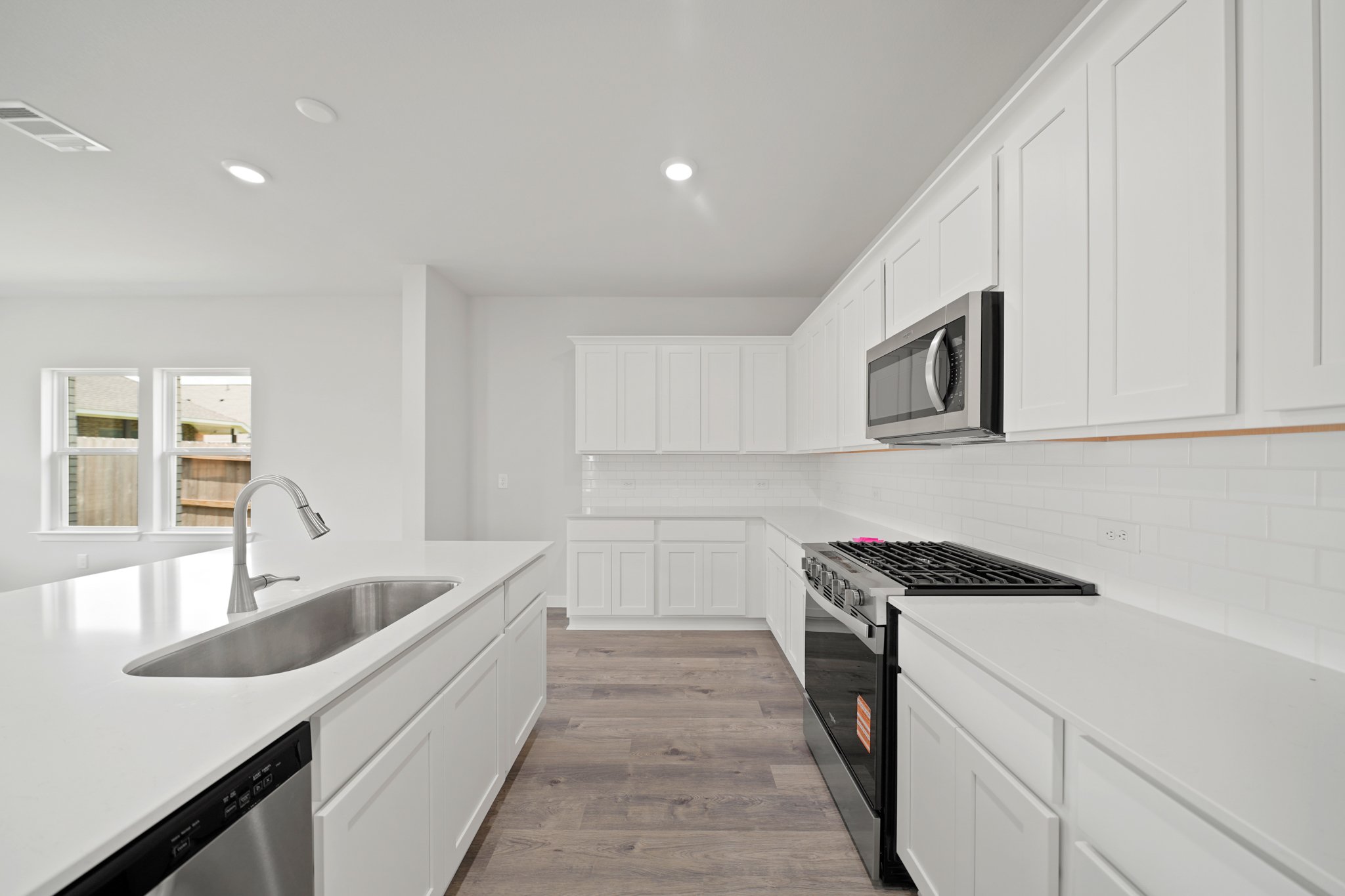 A kitchen with white cabinets.