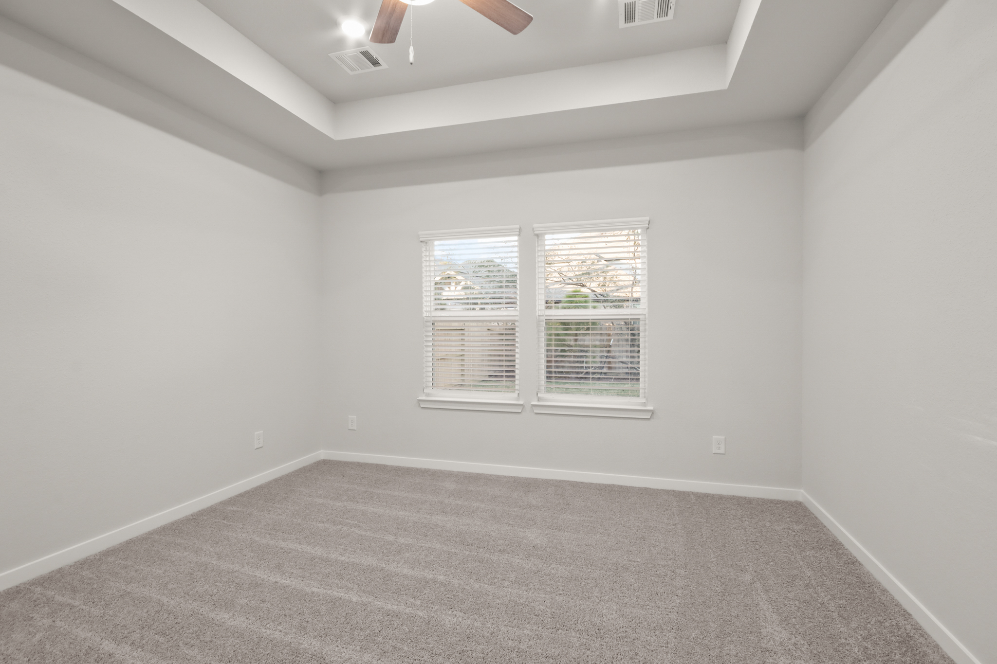 A room with a window and a carpet.