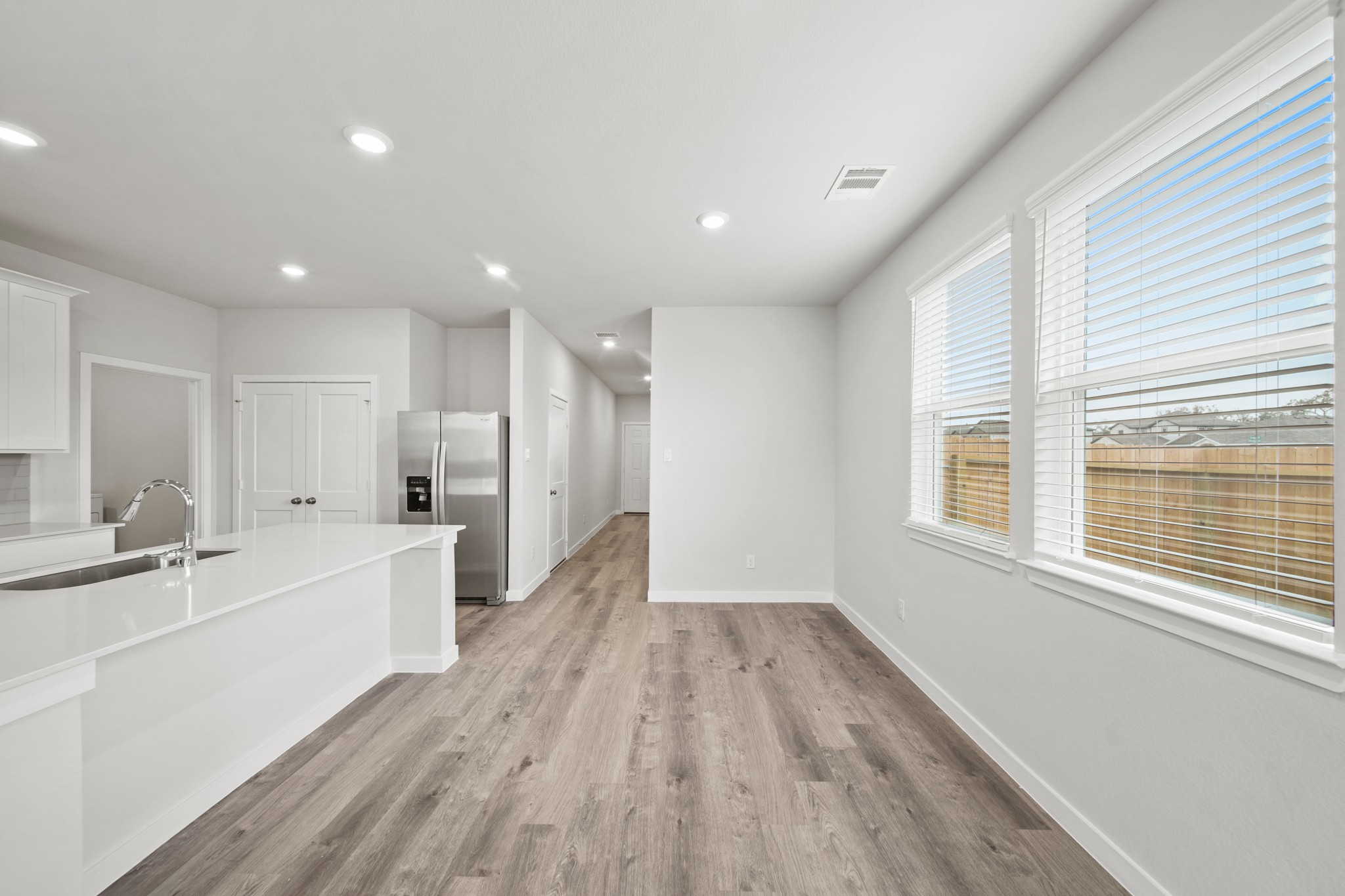 A large bathroom with a wood floor.