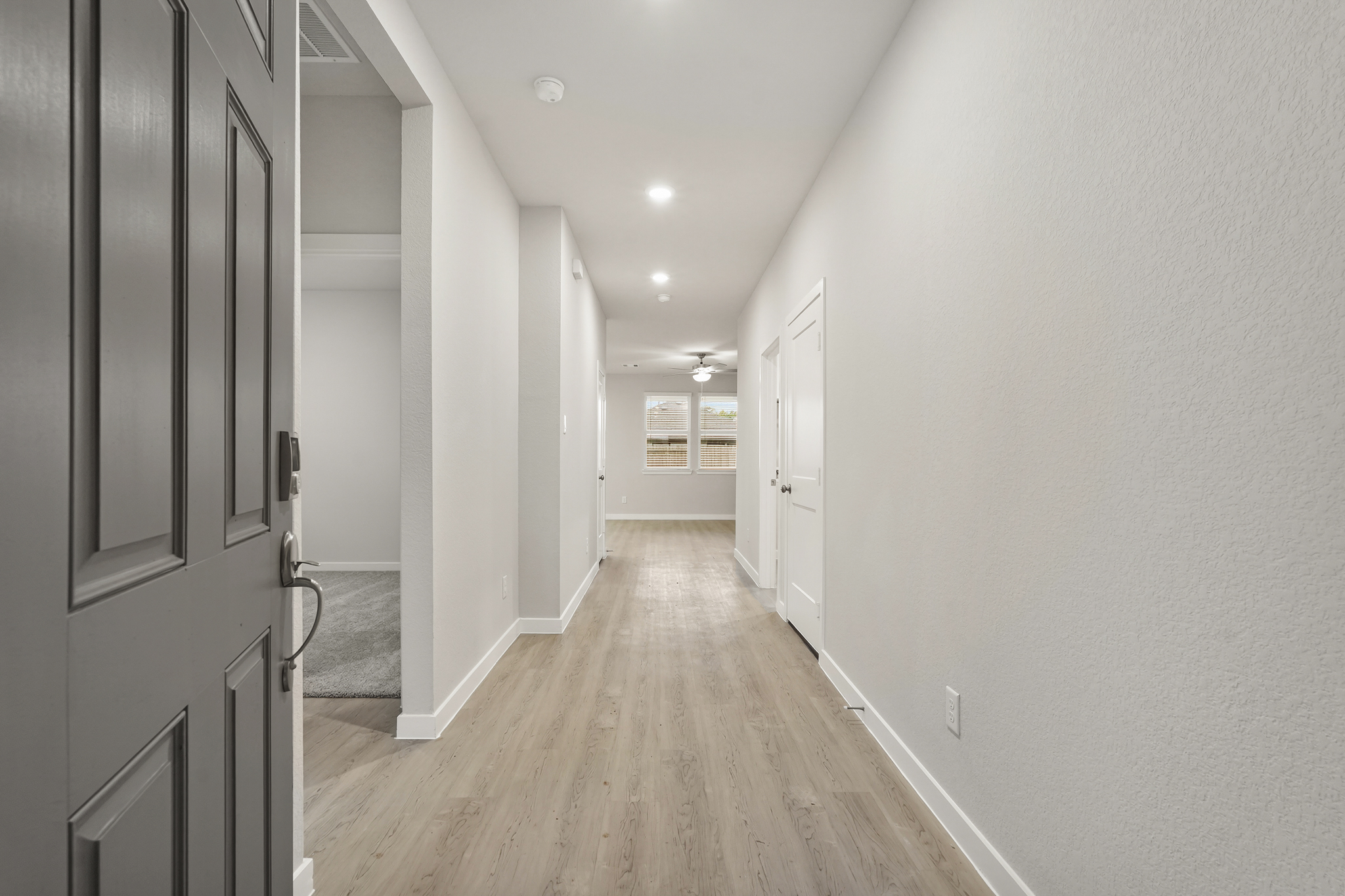 A hallway with white doors.