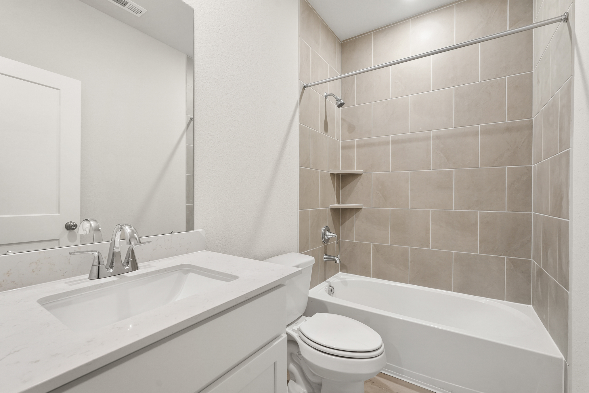 A bathroom with a tub sink and toilet.