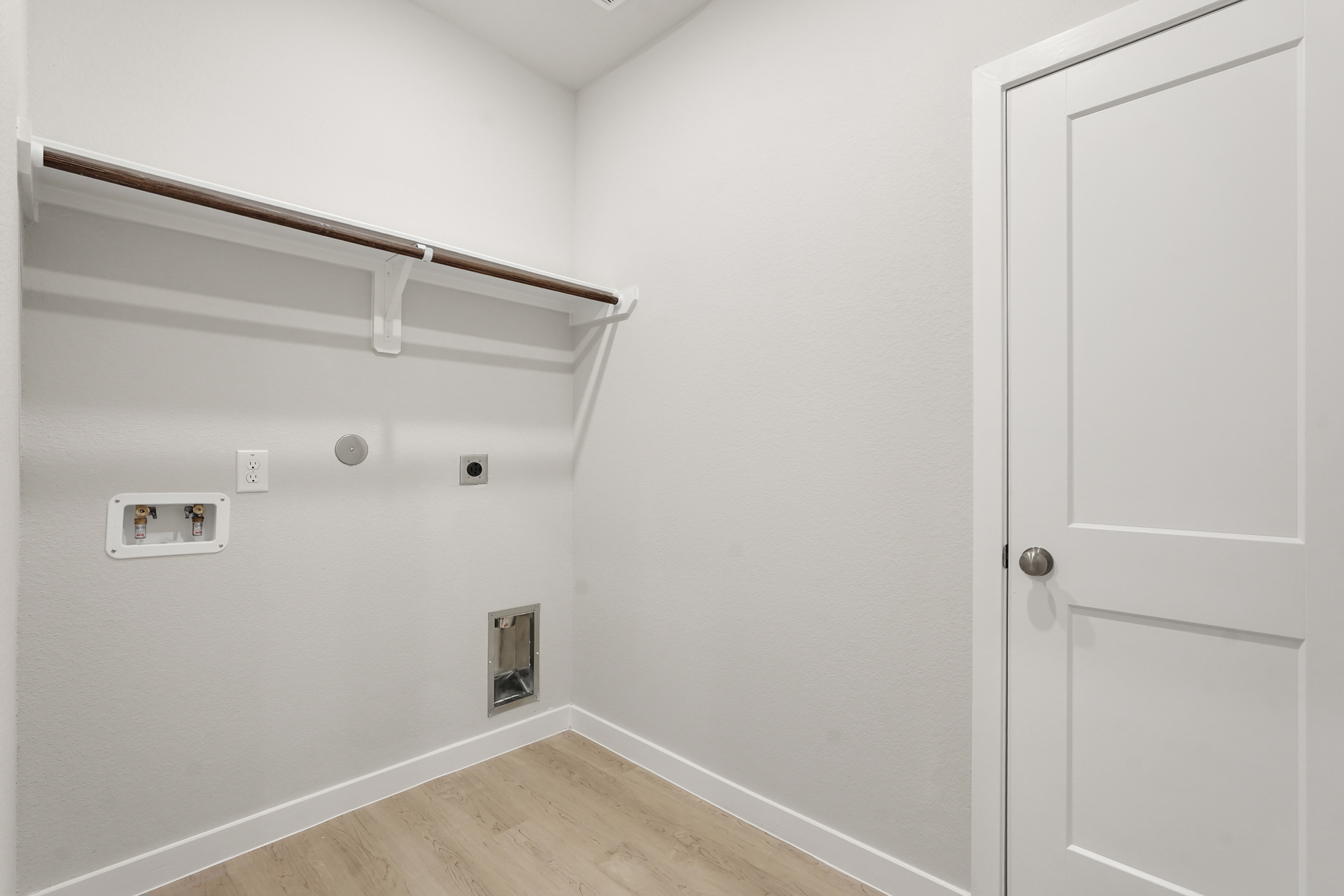 A white room with a white door.