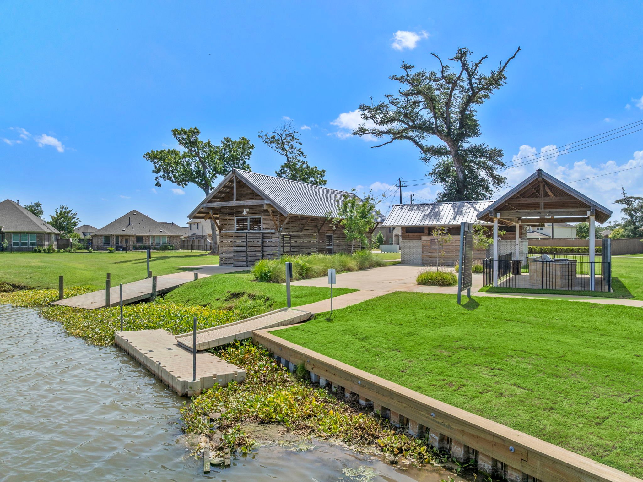 A small pond with a small building in the background.