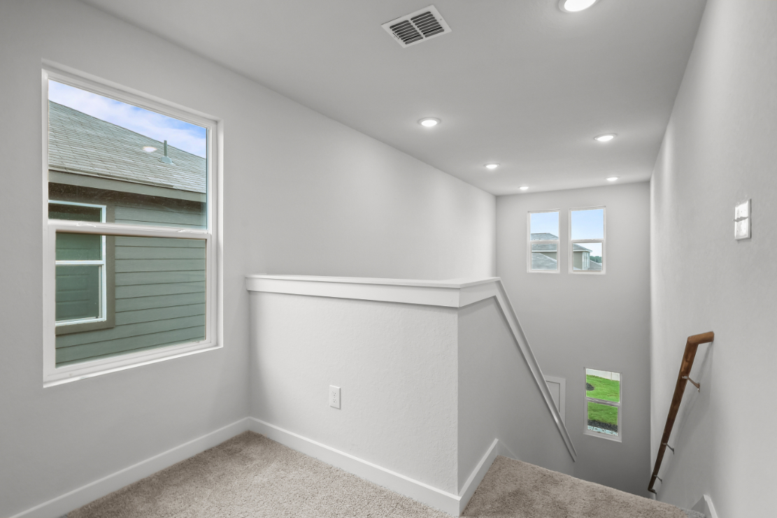 A room with a white wall and a window.