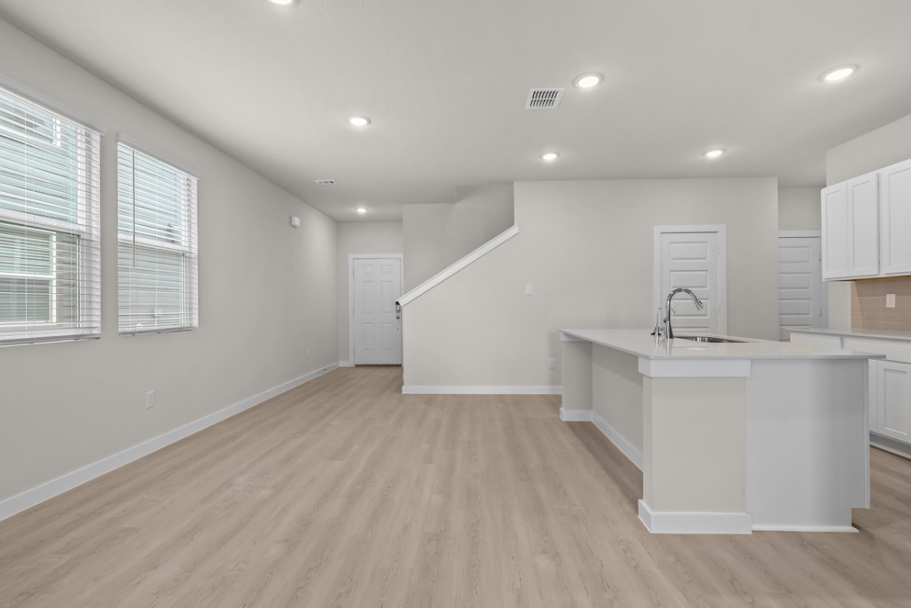 A kitchen with white cabinets.
