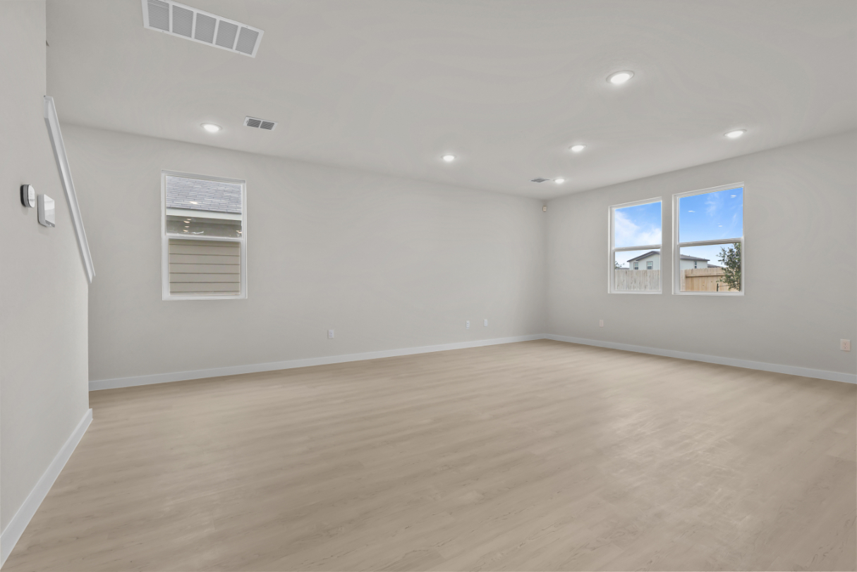 A room with a wood floor and a window.