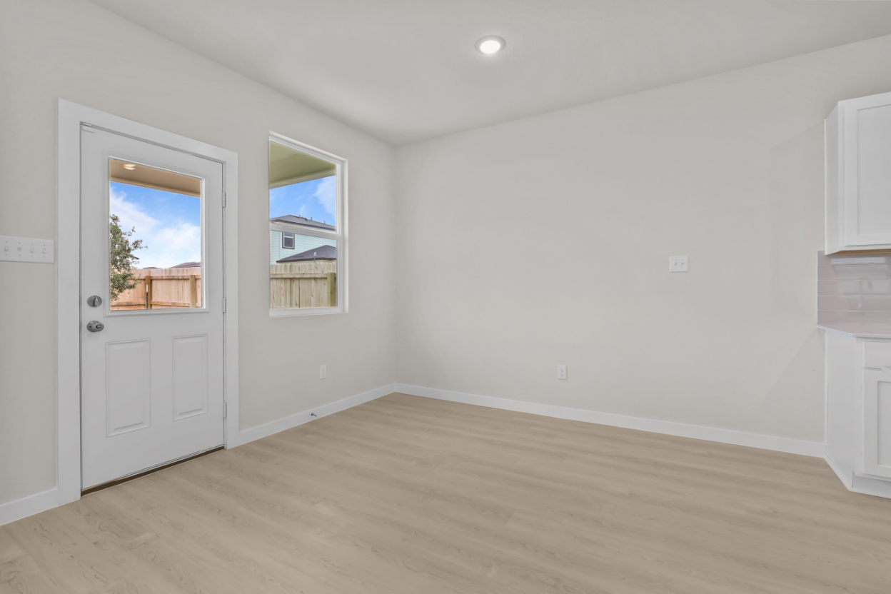 A room with white walls and a wood floor.