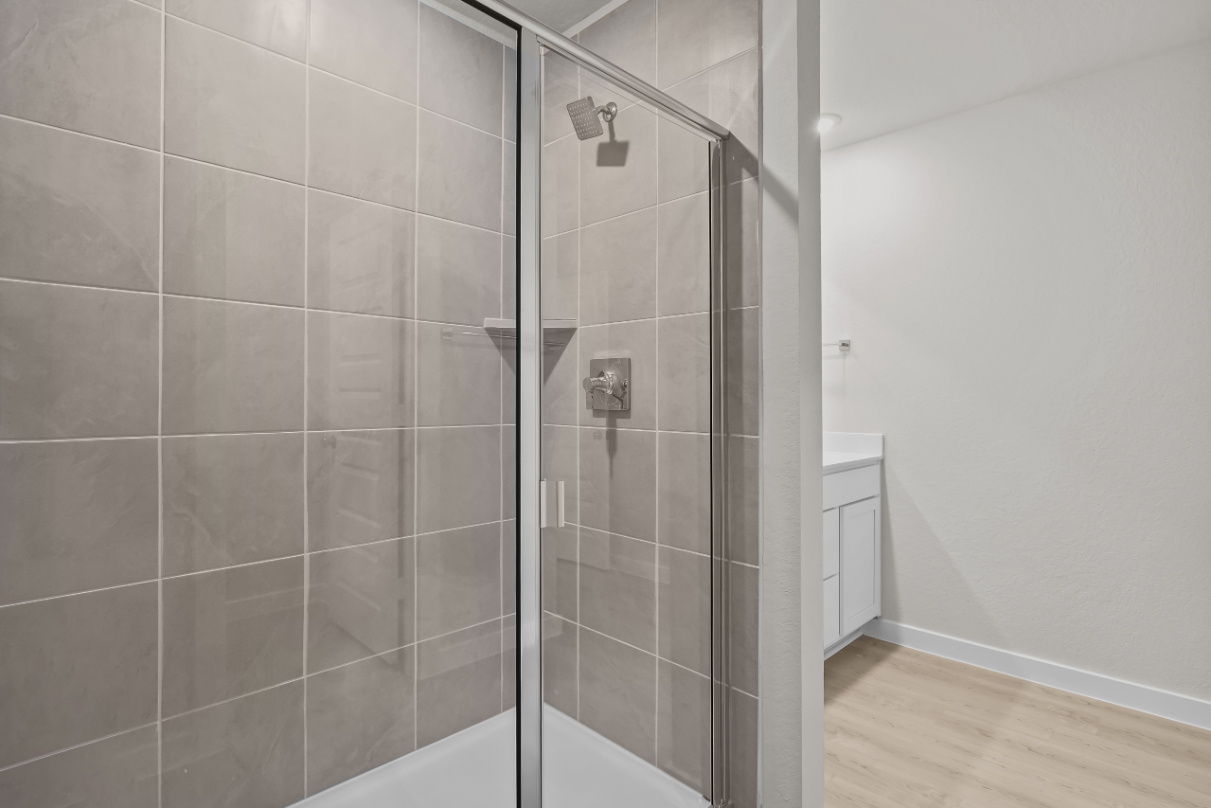 A shower with a glass door.