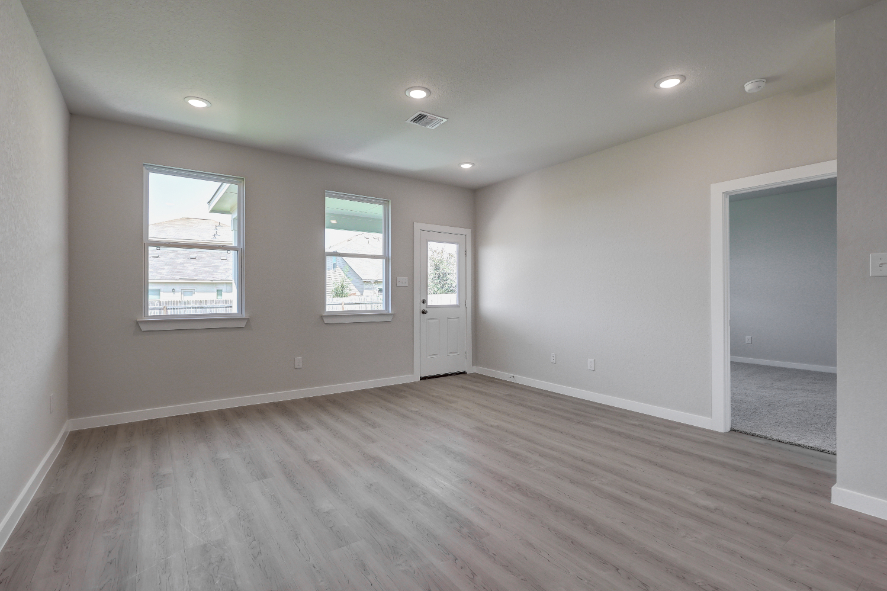 A room with a wood floor and white walls.