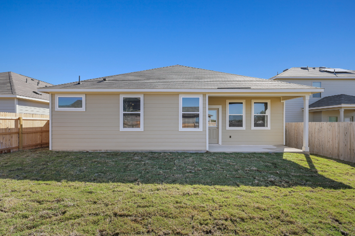 A house with a fence and grass.
