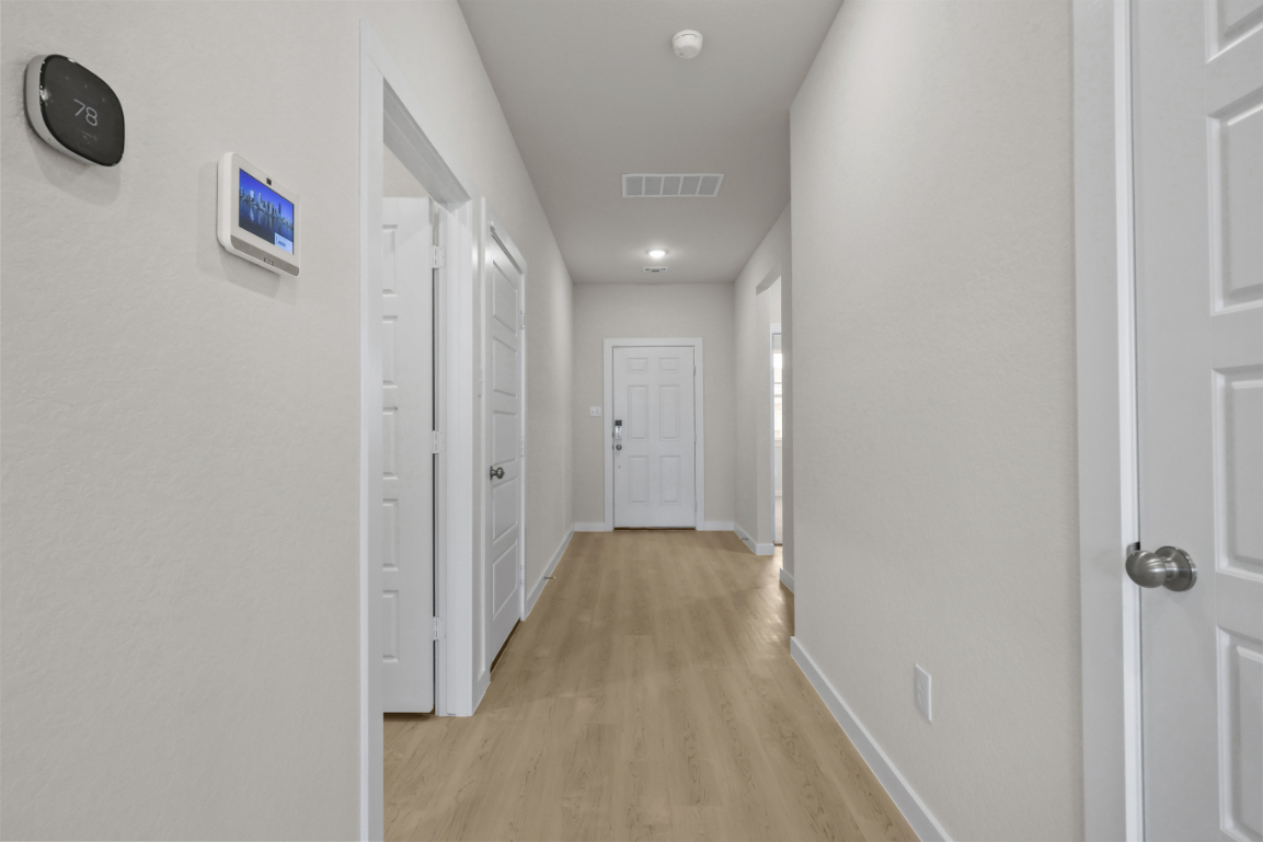A hallway with white doors.