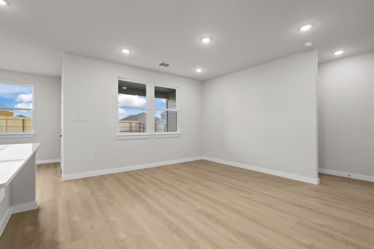 A room with a wood floor and a window.
