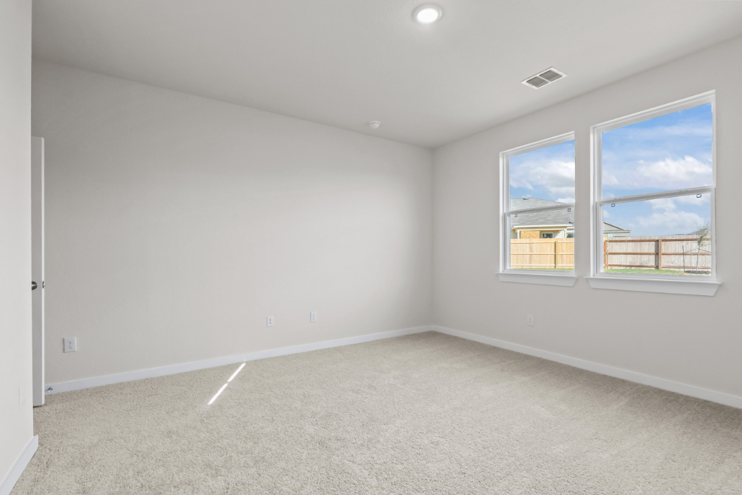A room with a window and a carpet.