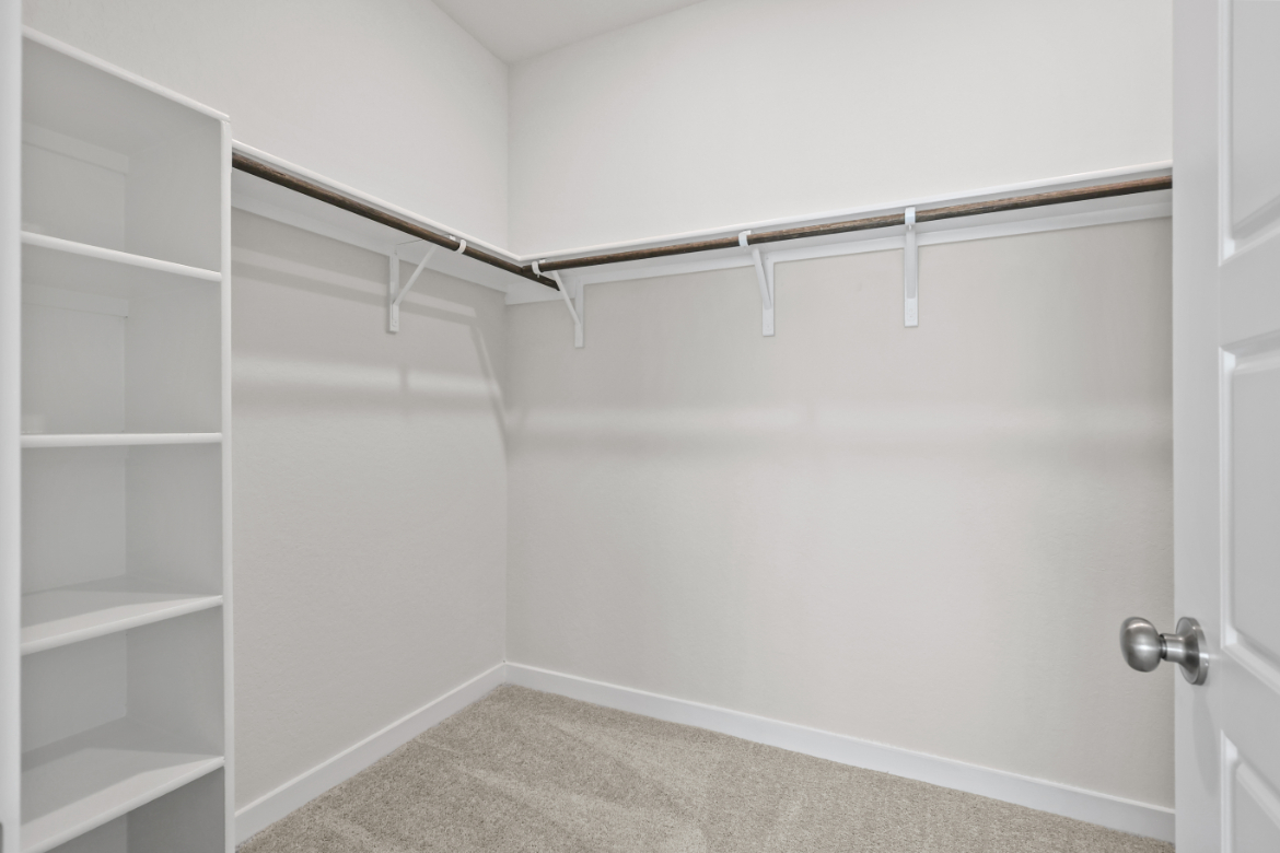 A white wall with a metal bar.