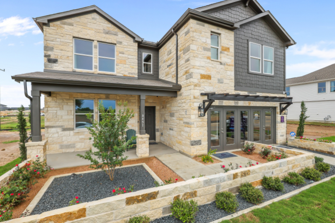 A house with a stone driveway.