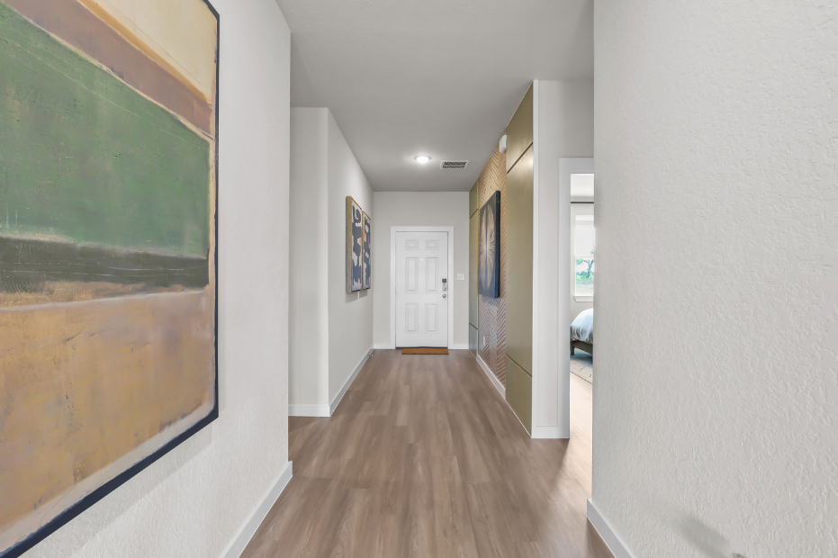 A hallway with a wood floor.