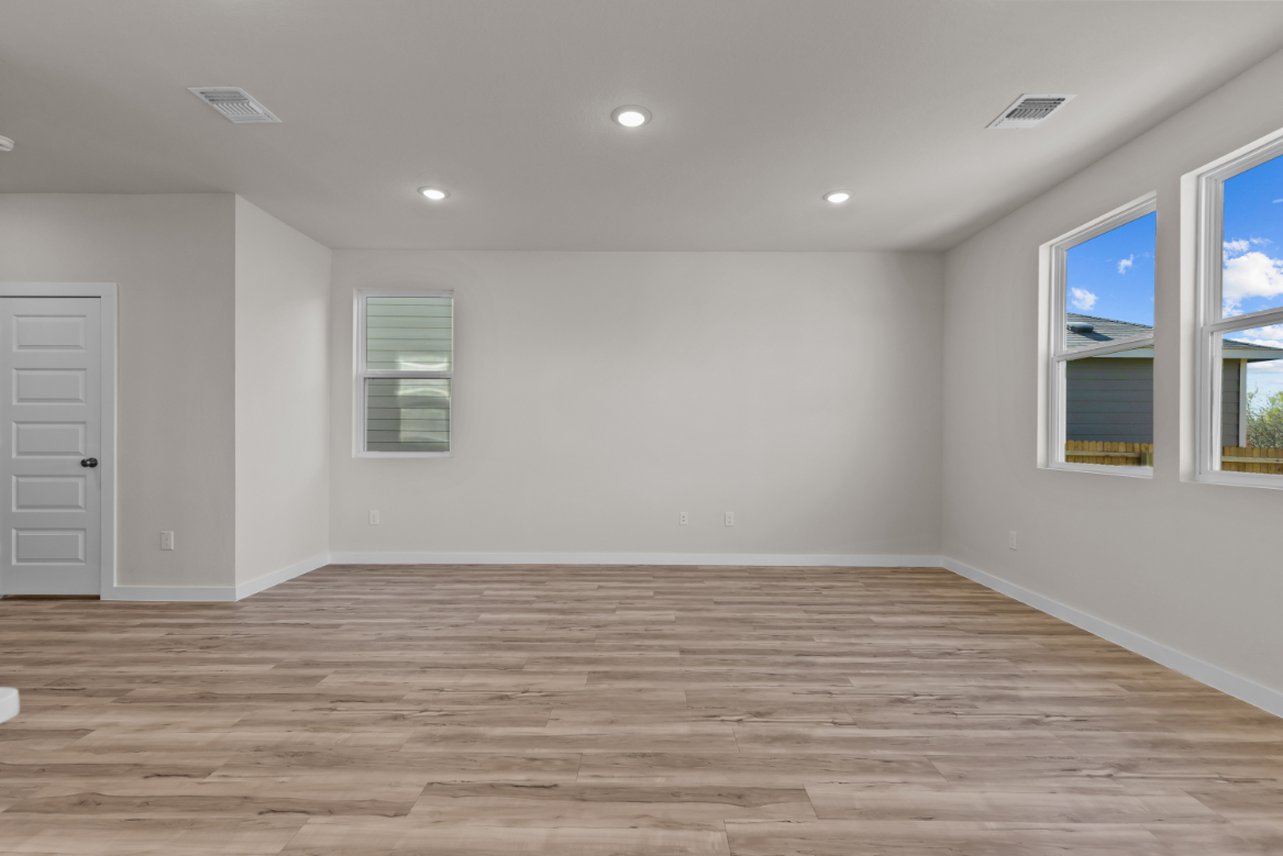 A room with a wood floor and white walls.