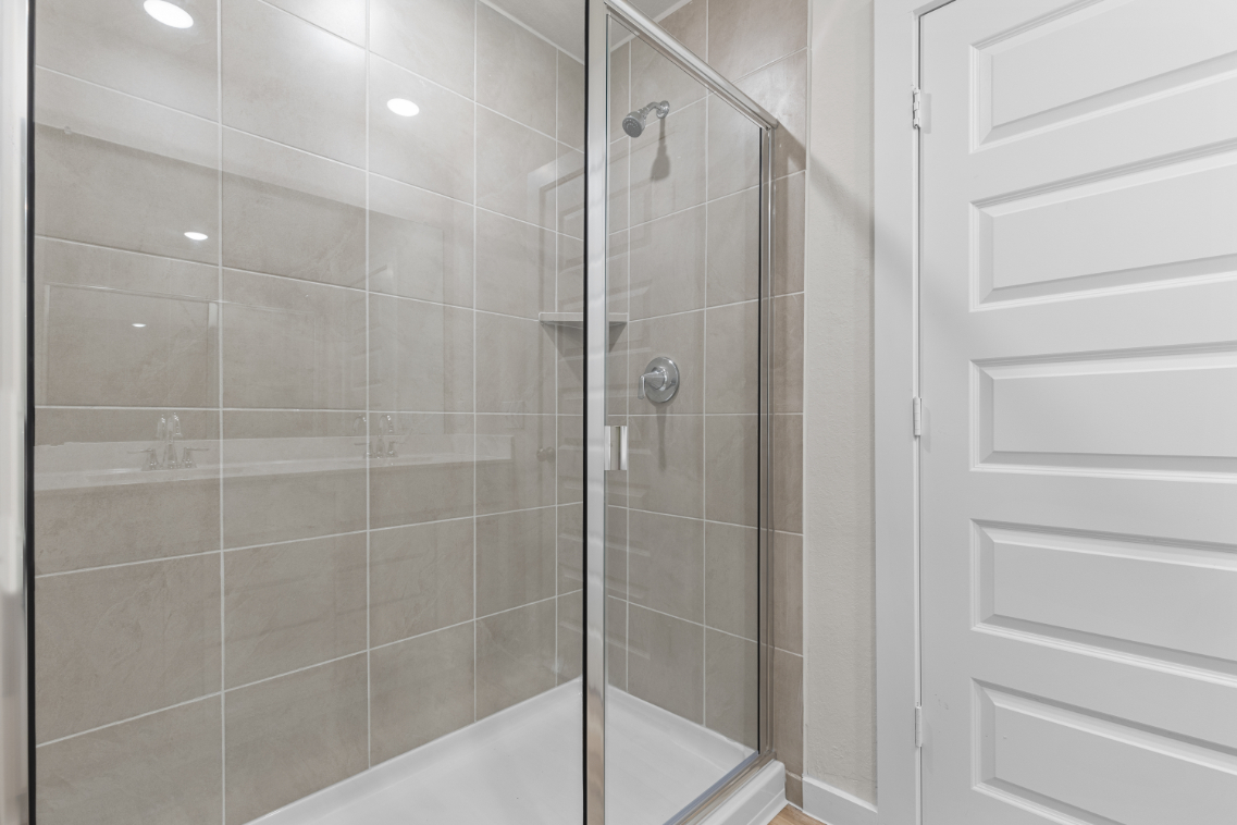 A shower with a glass door.