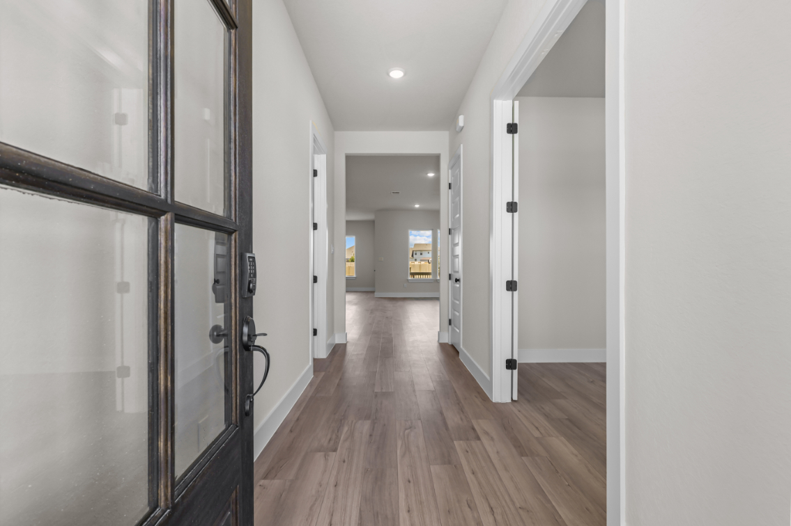 A hallway with glass doors.