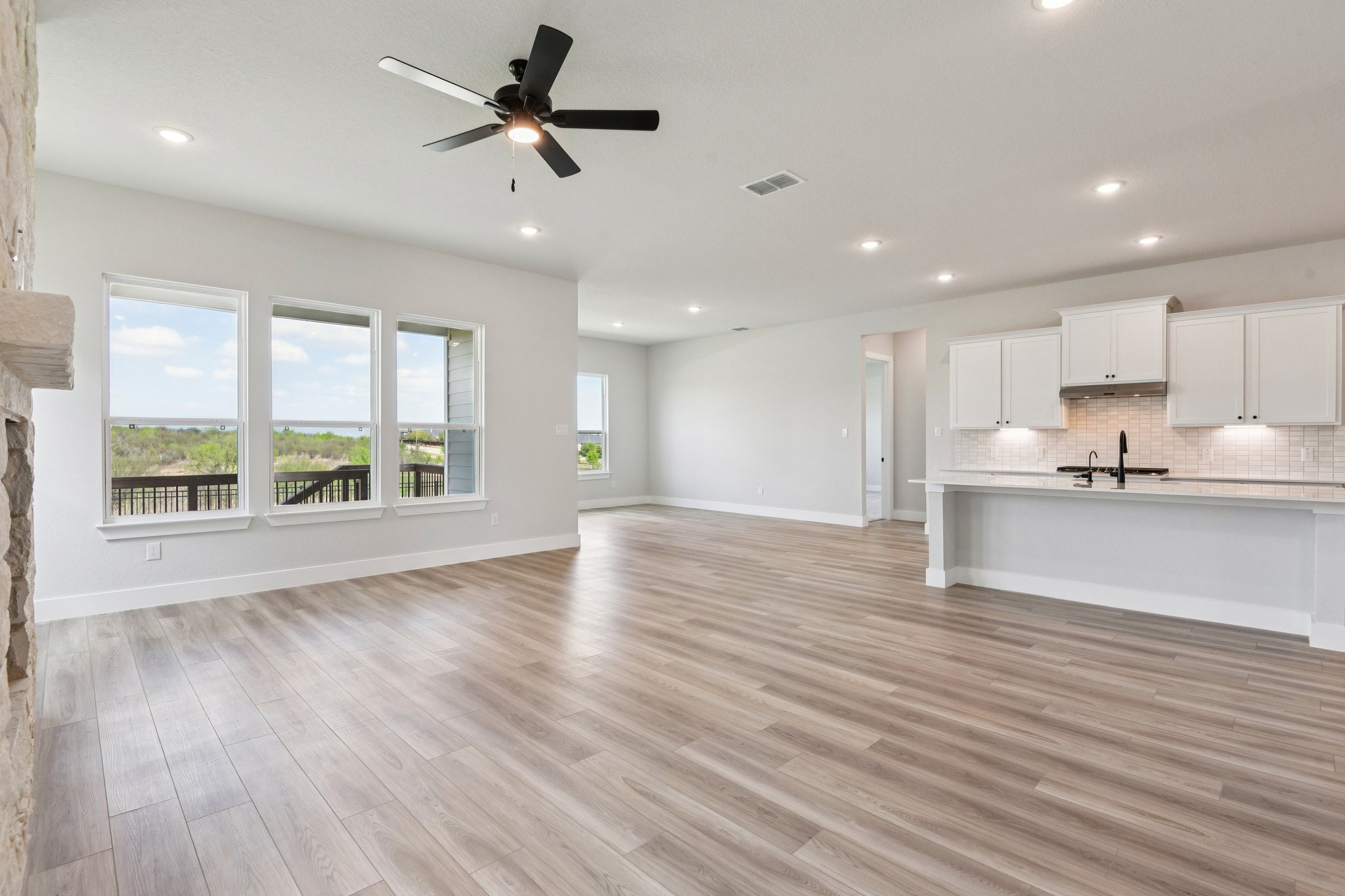 A large kitchen with a wood floor.