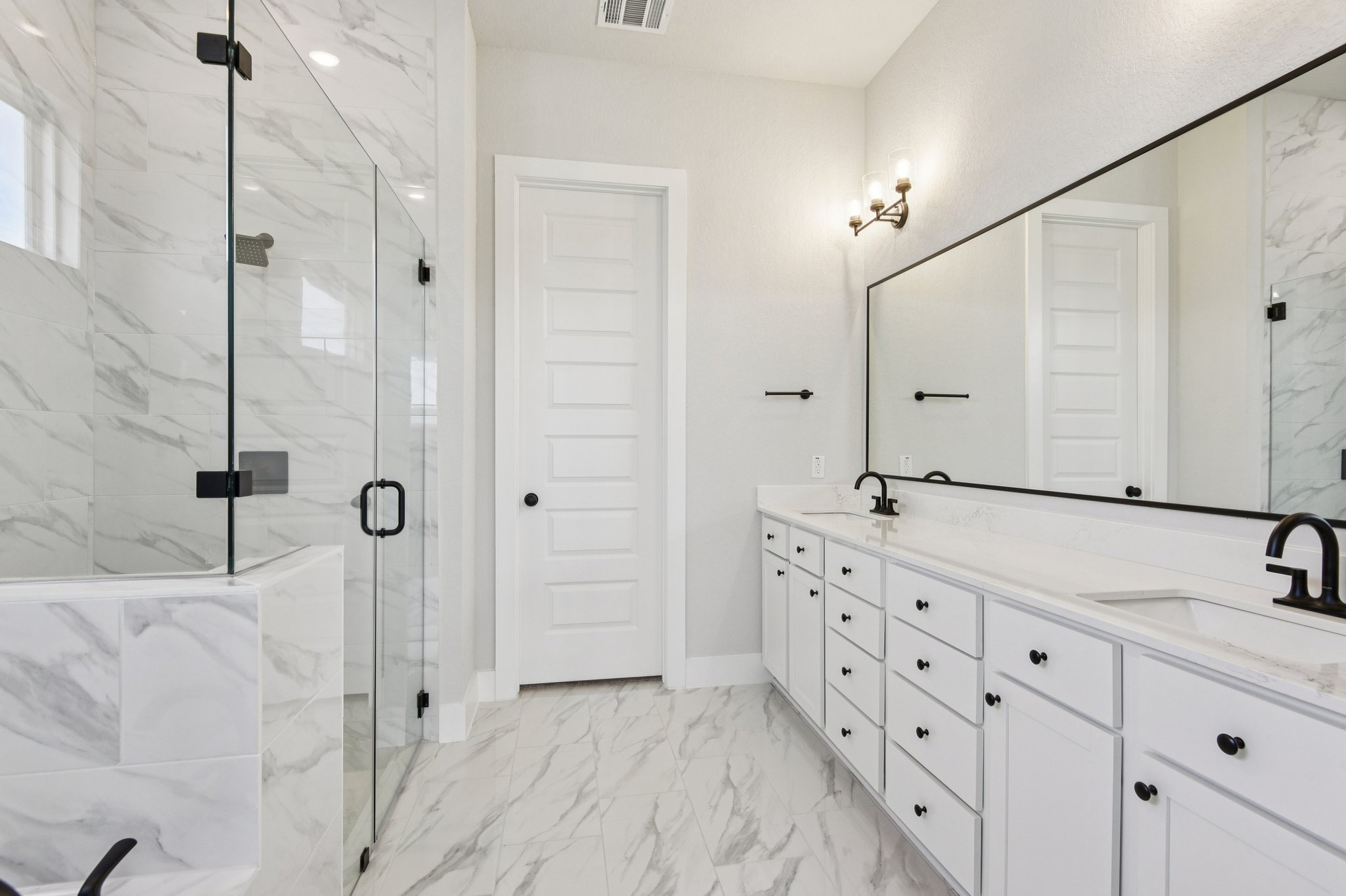 A bathroom with a glass shower.