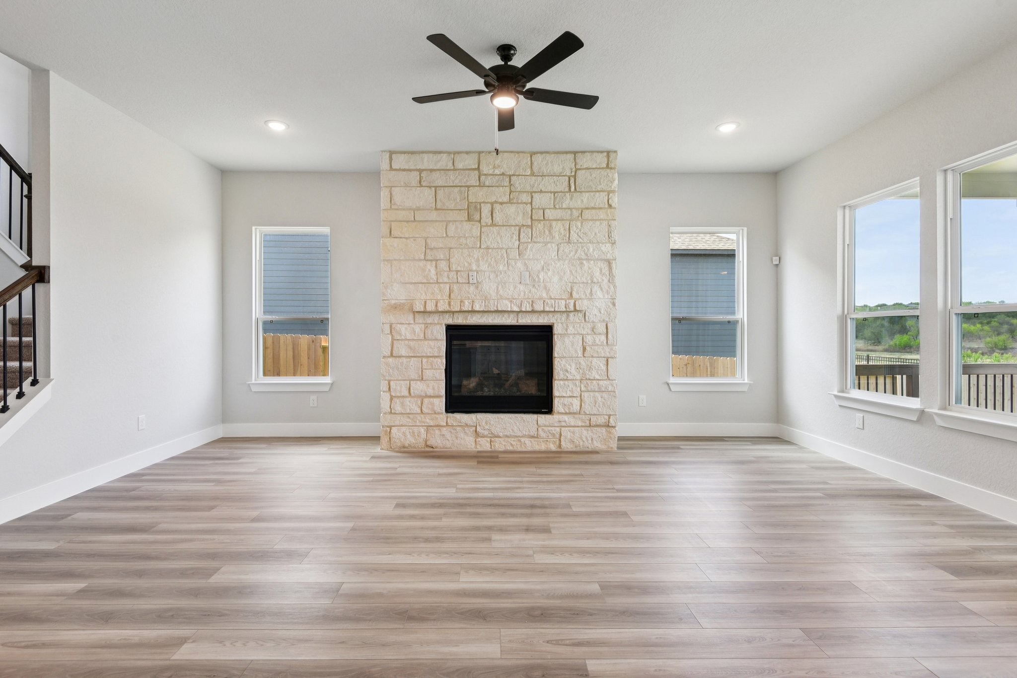 A room with a fireplace and a wood floor.