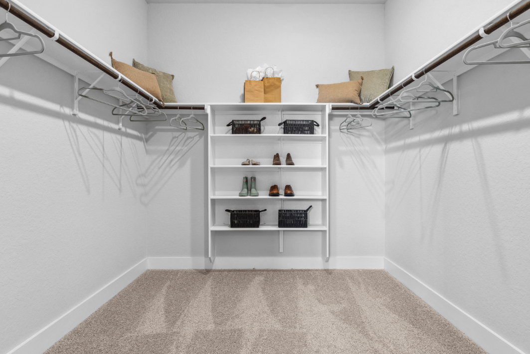 A white room with shelves and a white wall.