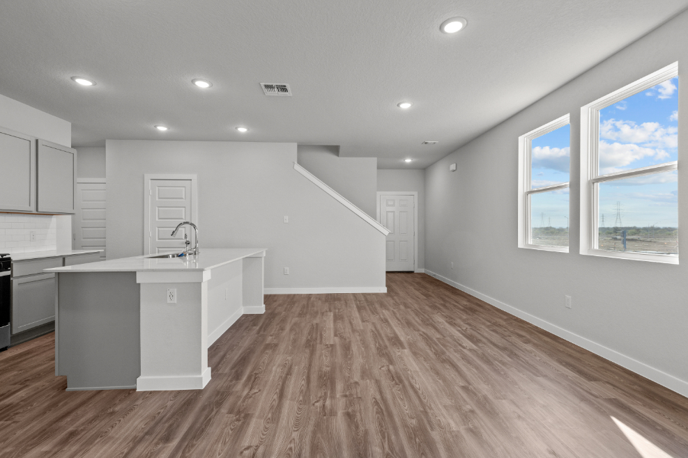 A kitchen with white cabinets.