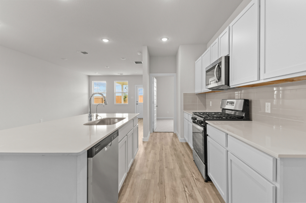 A kitchen with white cabinets.