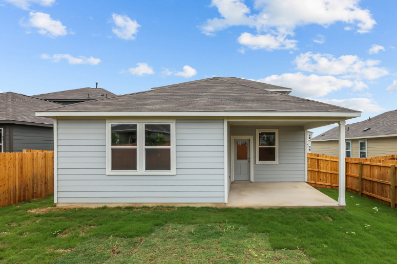 A house with a fence and grass.