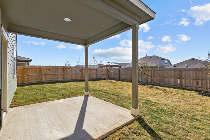 A deck with a fence and grass.